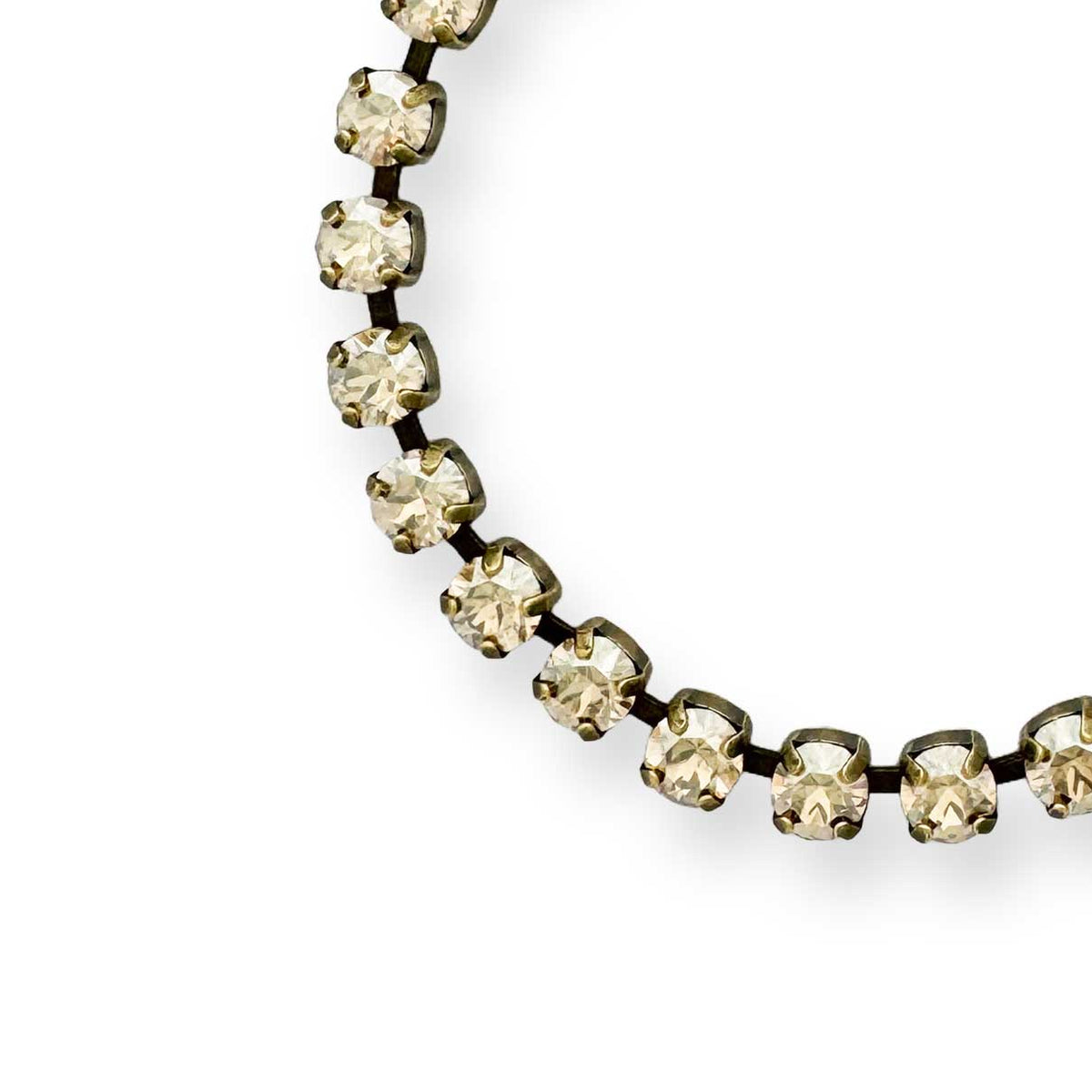 Gold rhinestone tennis bracelet show in antique brass.