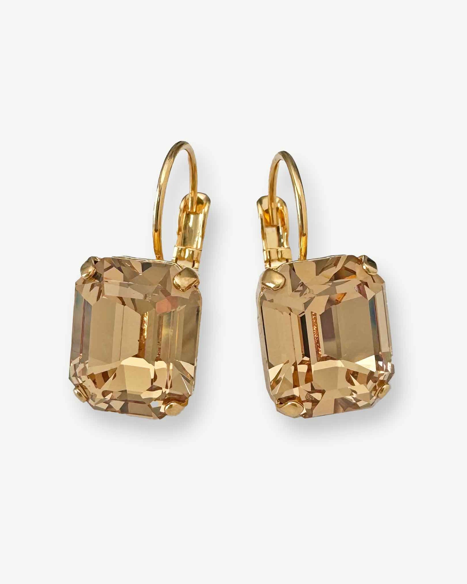 Emerald cut light topaz crystal earrings shown in gold with leverback closure.
