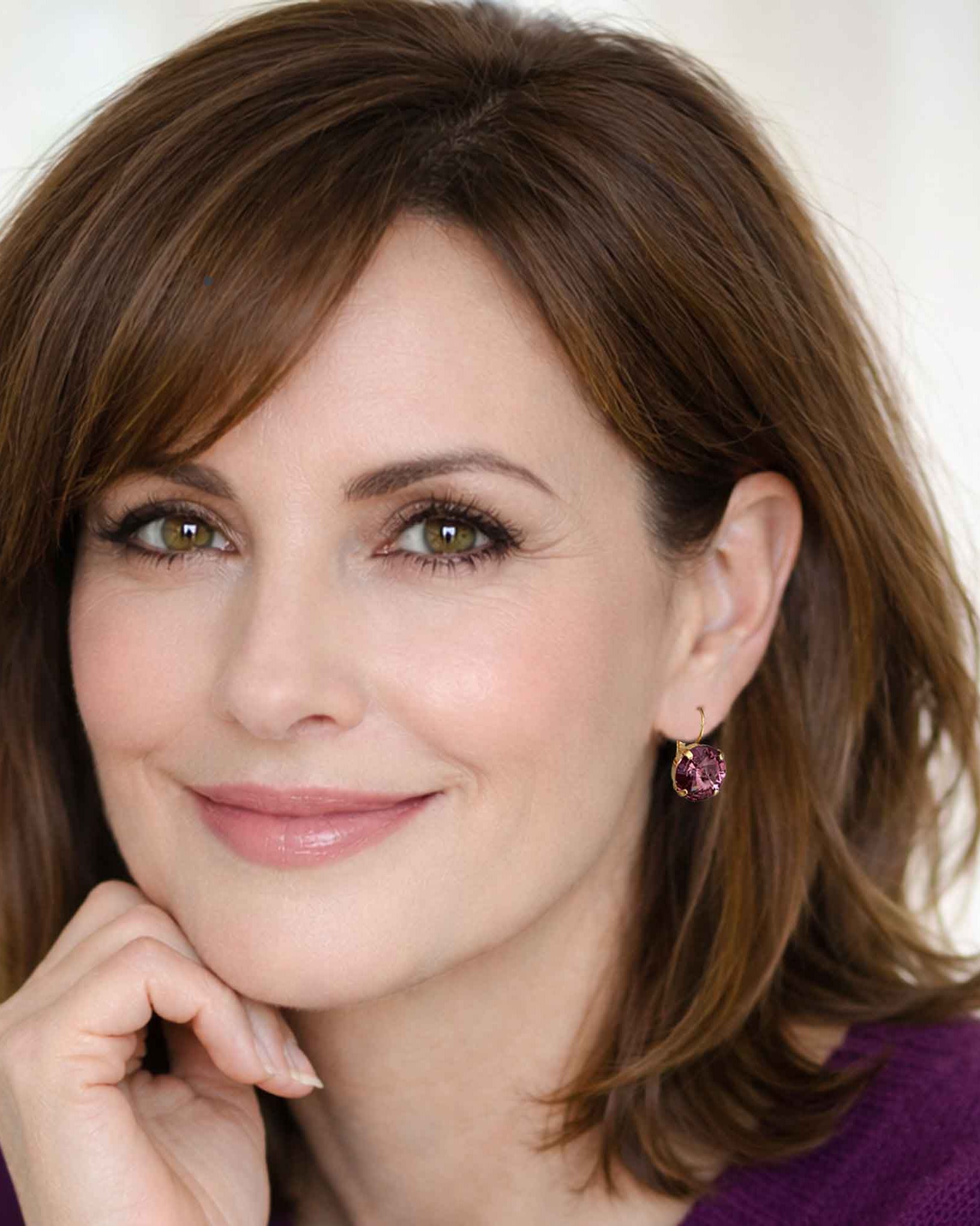 Woman modeling purple drop earrings by Petite Margaux.