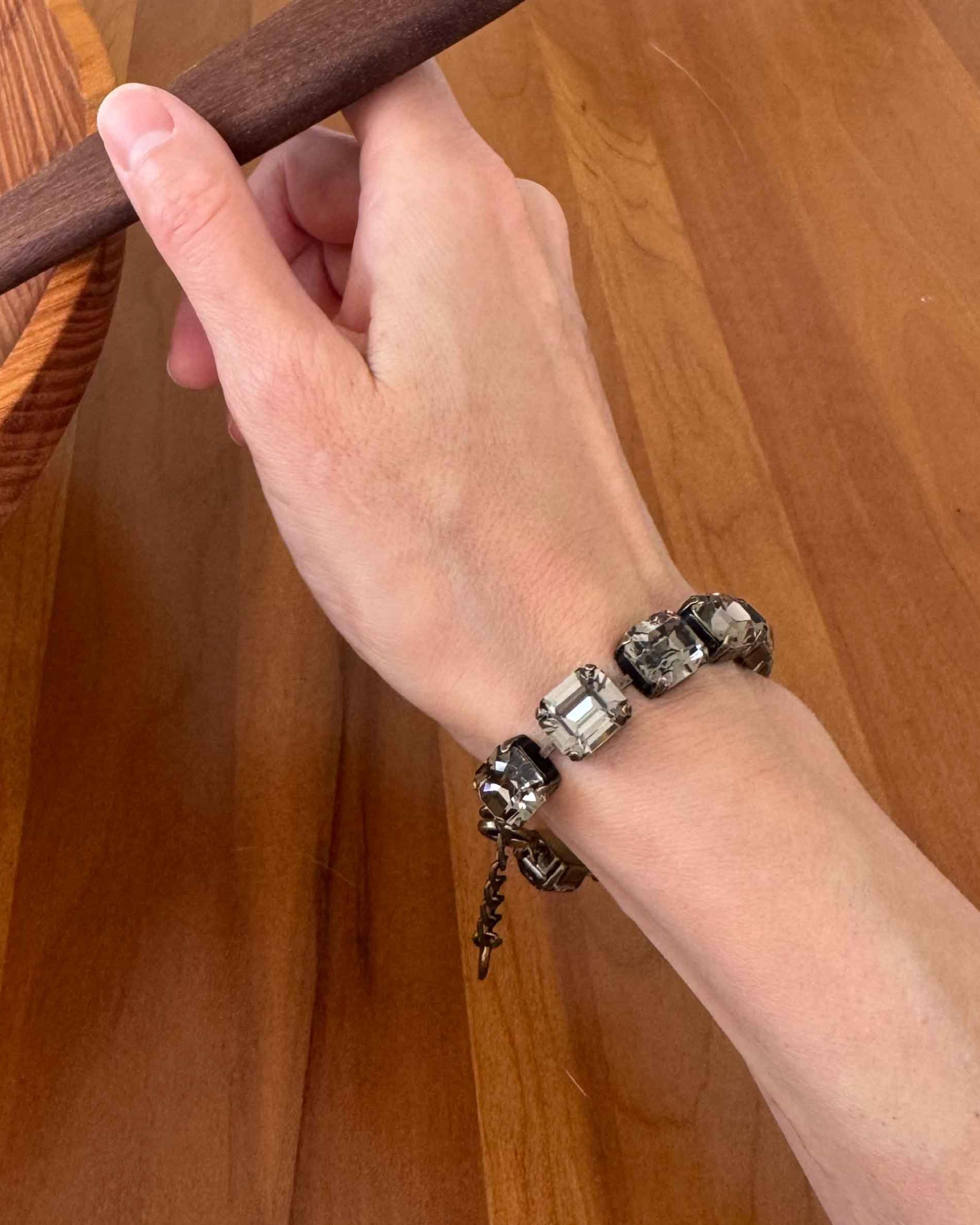 Emerald cut black diamond crystal bracelet by Petite Margaux shown on a wrist.