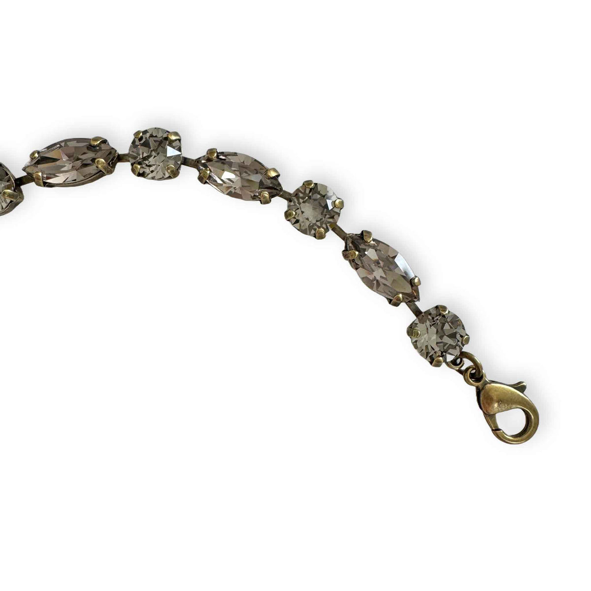 close up of antique brass version of warm gray crystal bracelet.