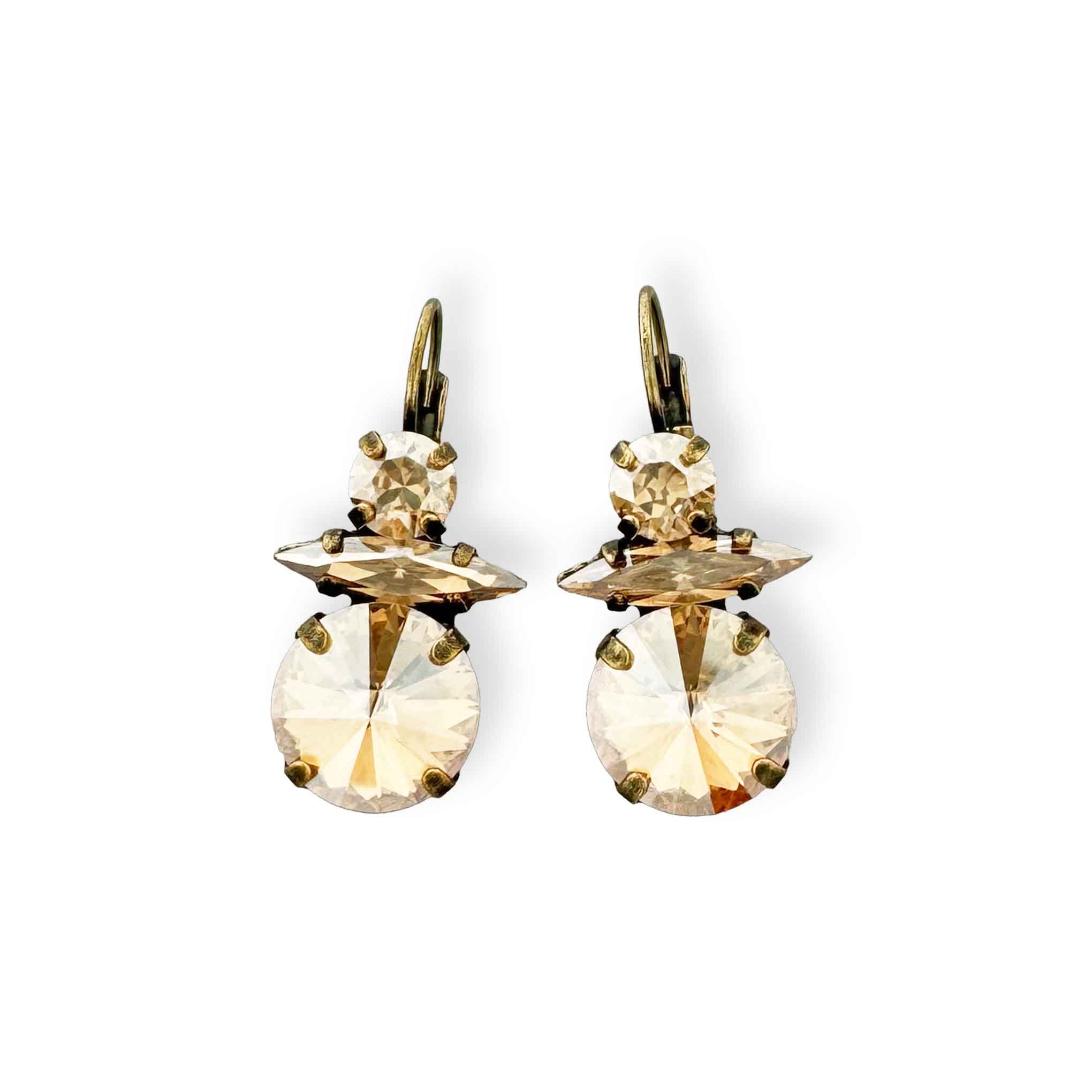 Unique champagne drop earrings shown in antique brass.