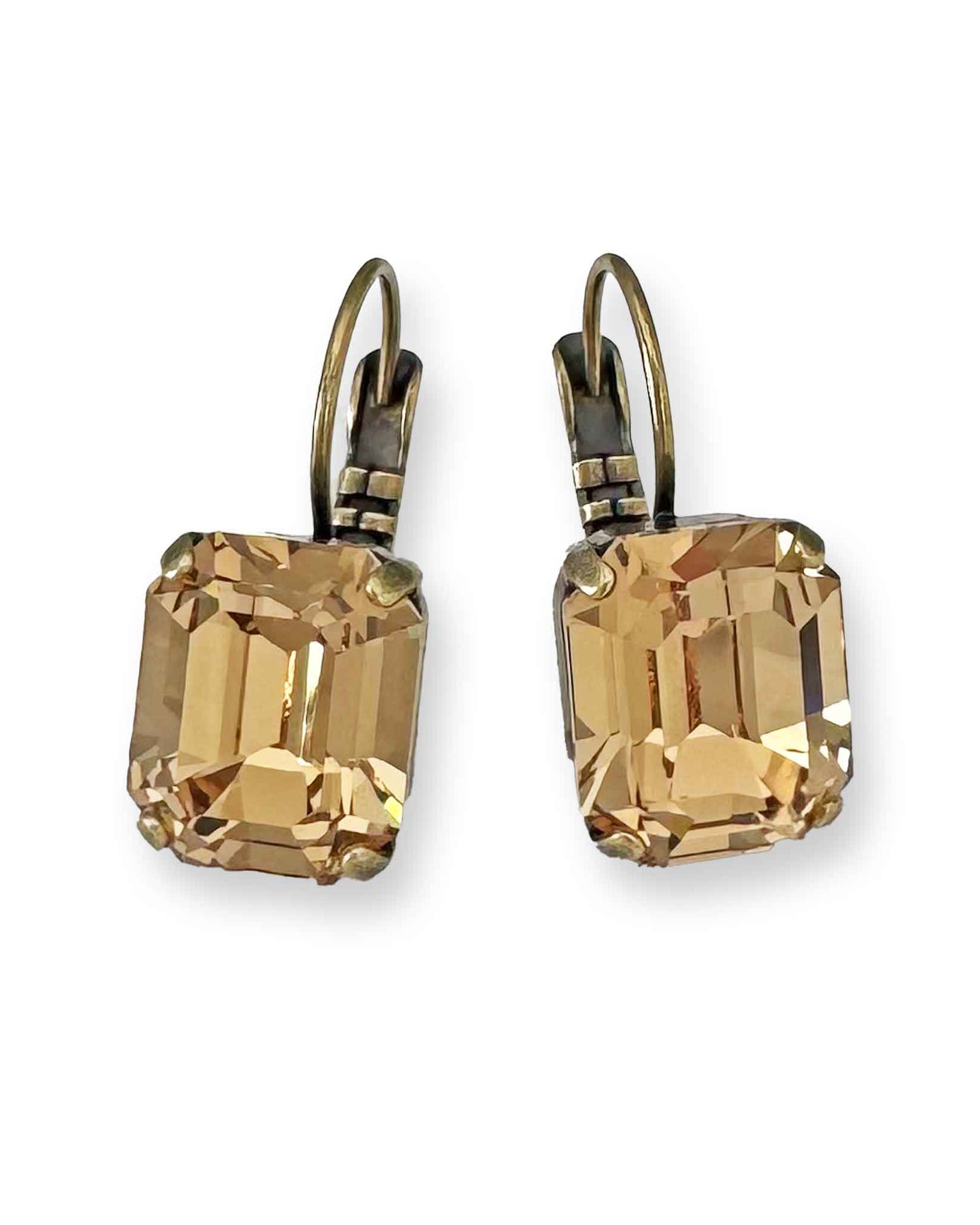 Emerald-cut light topaz crystal drop earrings shown in antique brass.