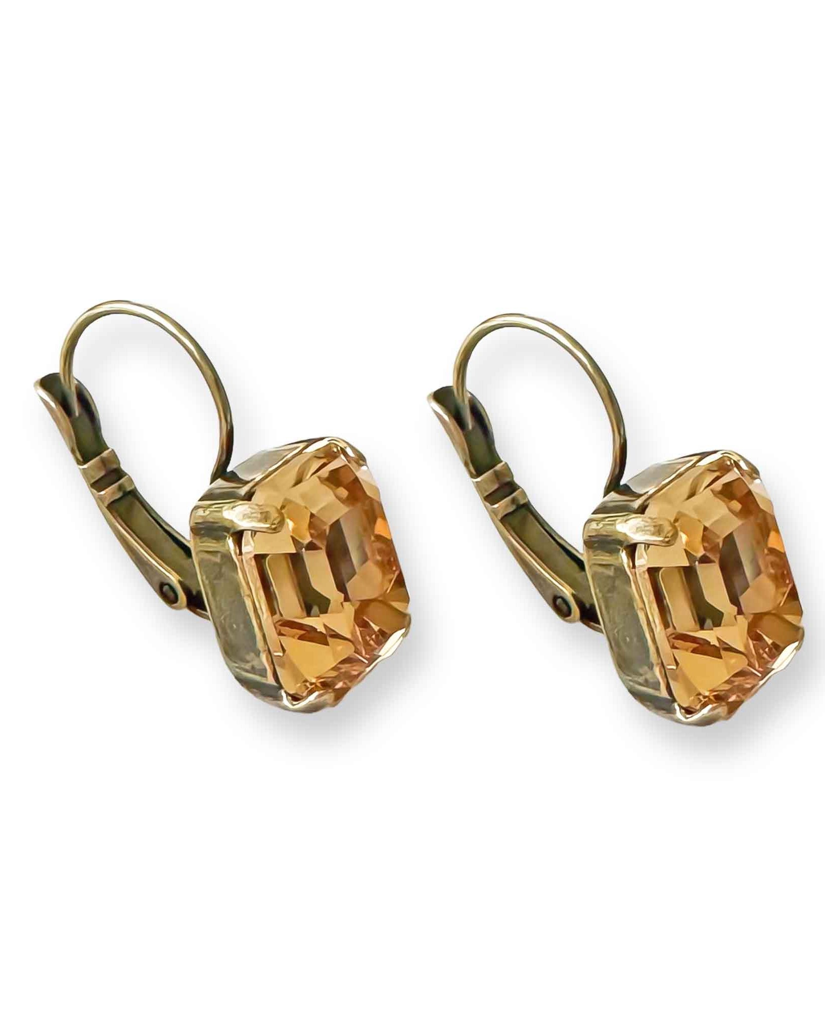 Side view of antique brass and light topaz crystal drop earrings.