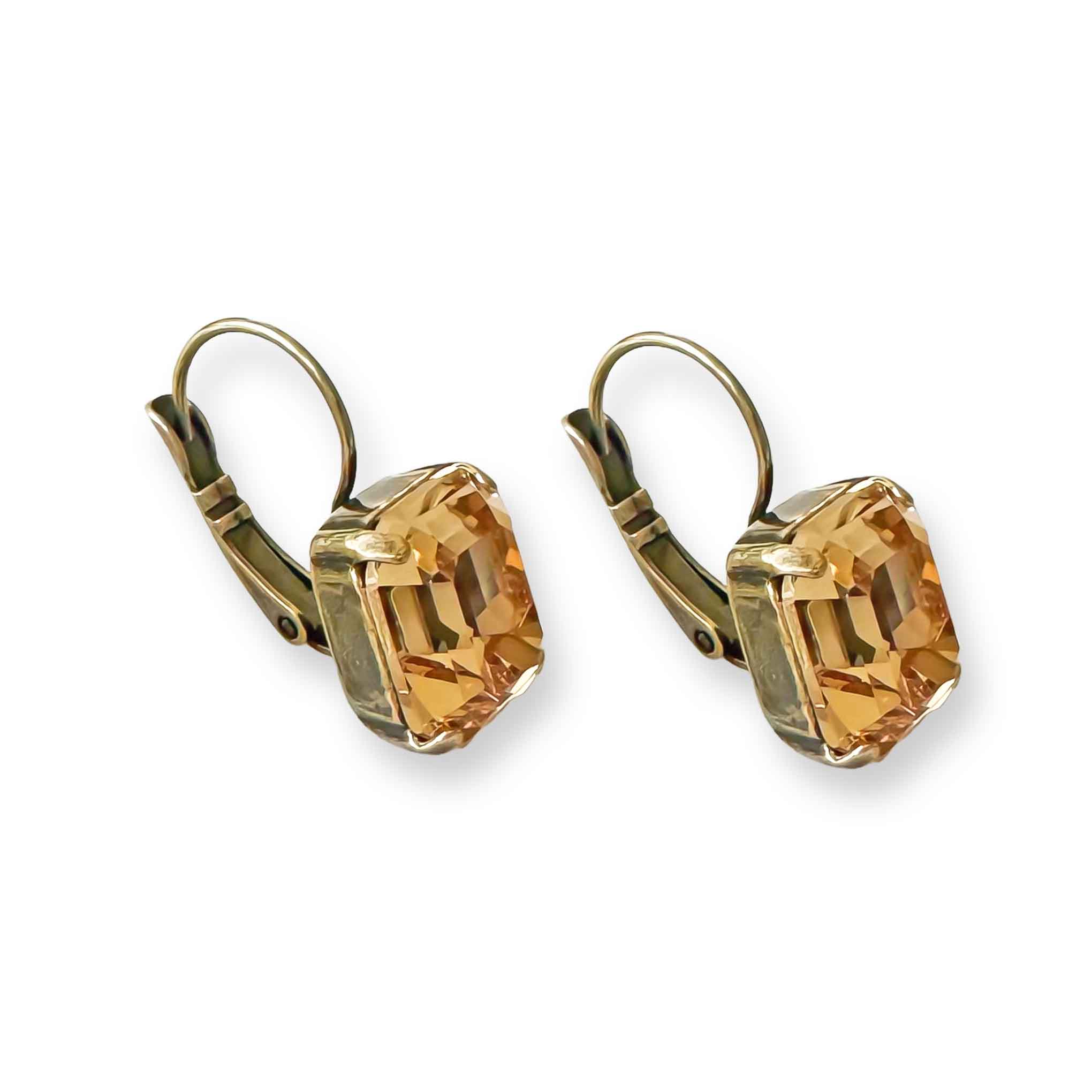 Side view of antique brass and light topaz crystal drop earrings.