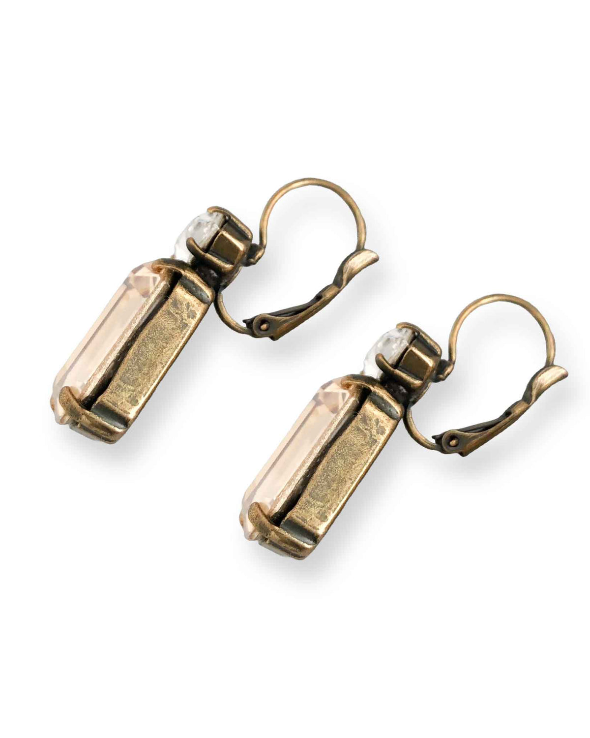 Side view of emerald cut champagne crystal statement earrings shown on white background.