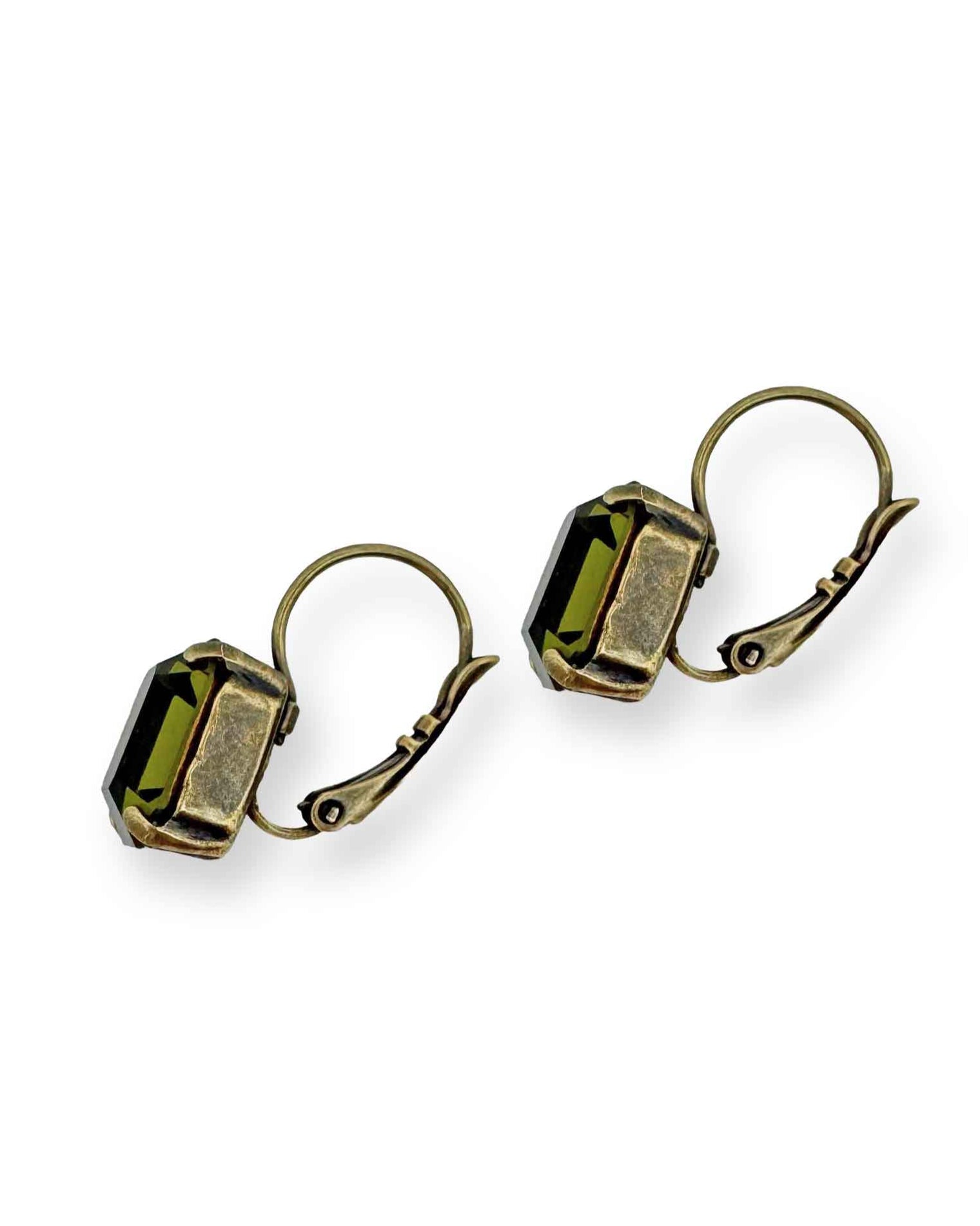 Side view of brass and olive green crystal drop earrings.