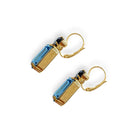 Side view of blue crystal earrings in a gold setting.