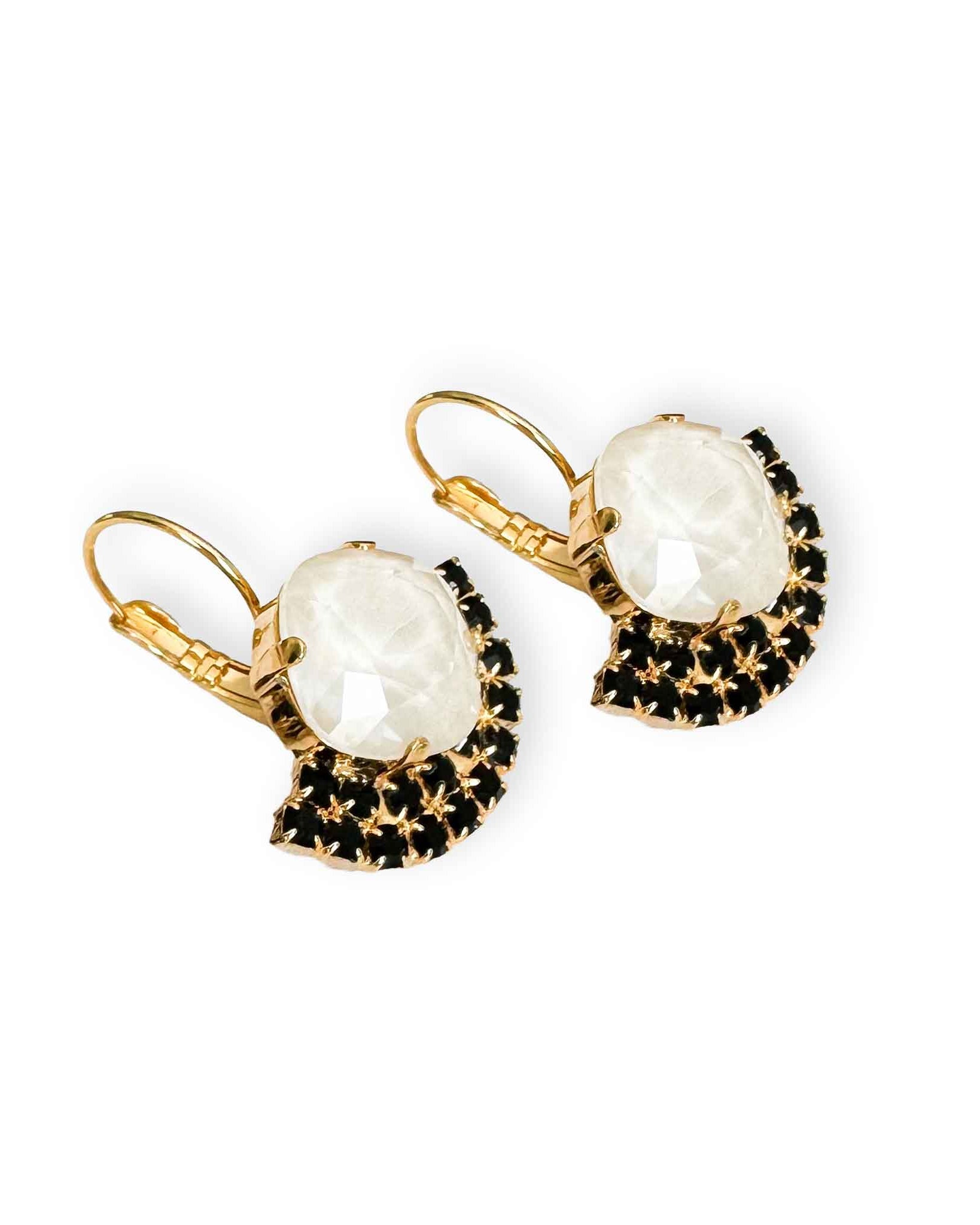 Side view of black and white crystal drop earrings in gold.