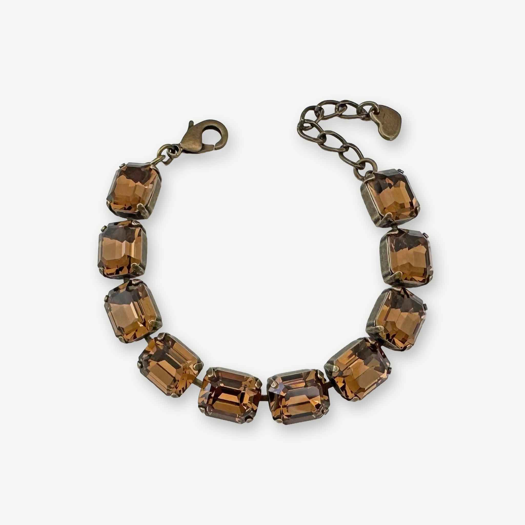 Emerald cut dark brown crystal tennis style bracelet shown in antique brass.