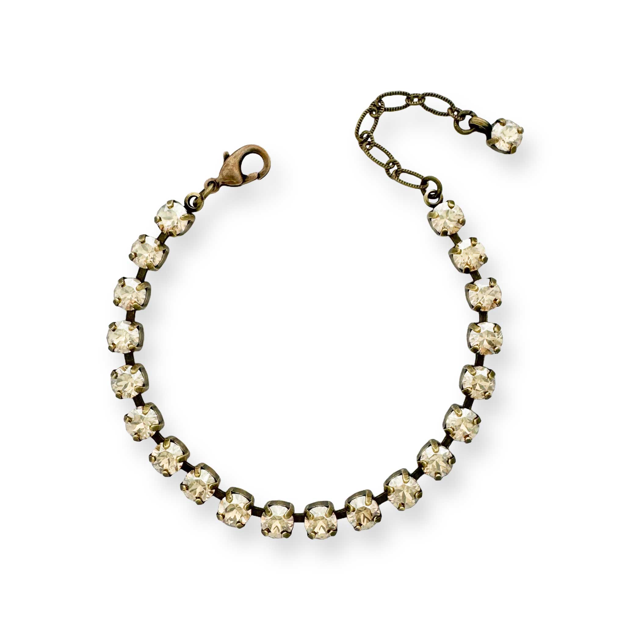 Gold rhinestone tennis bracelet show in antique brass.