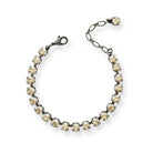 Delicate champagne crystal tennis bracelet shown in antique silver finish.