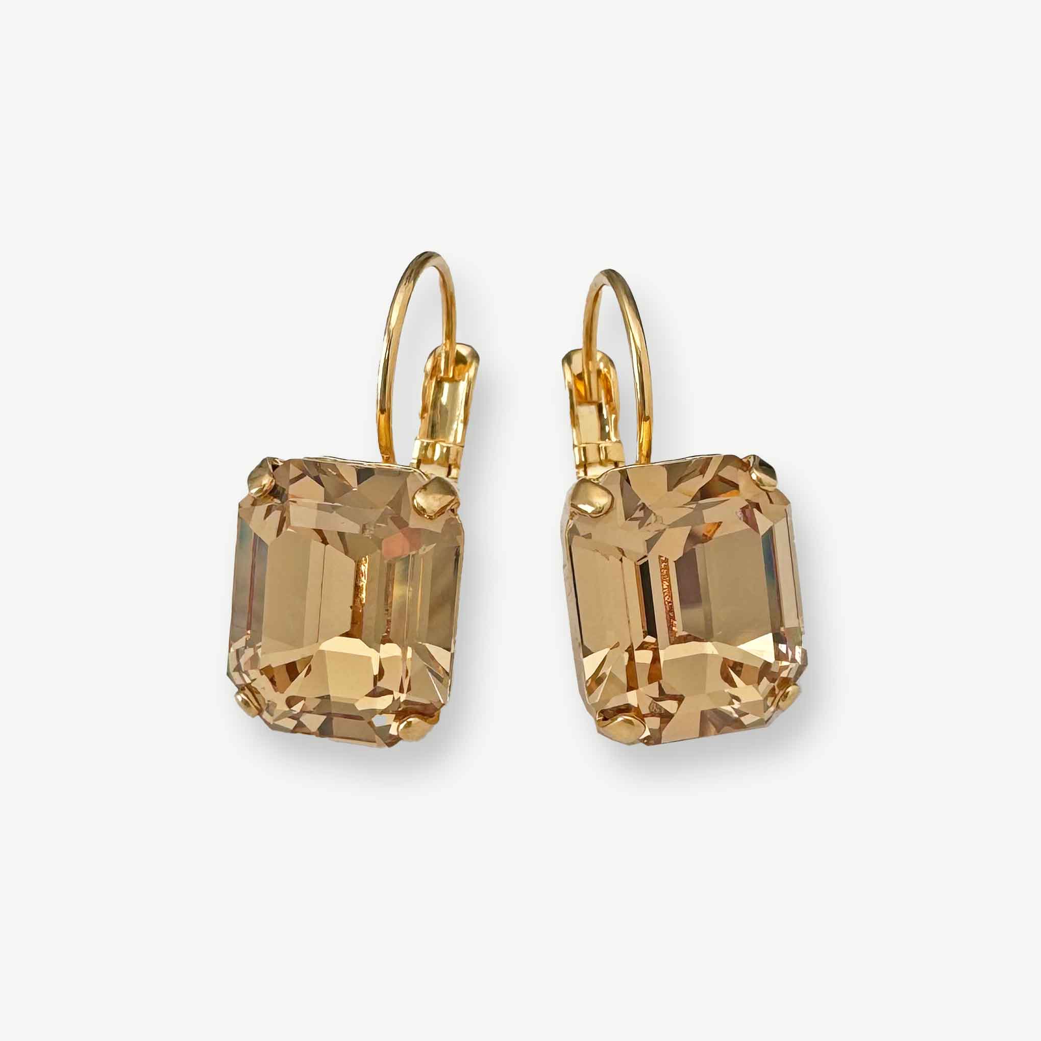 Emerald cut light topaz crystal earrings shown in gold with leverback closure.