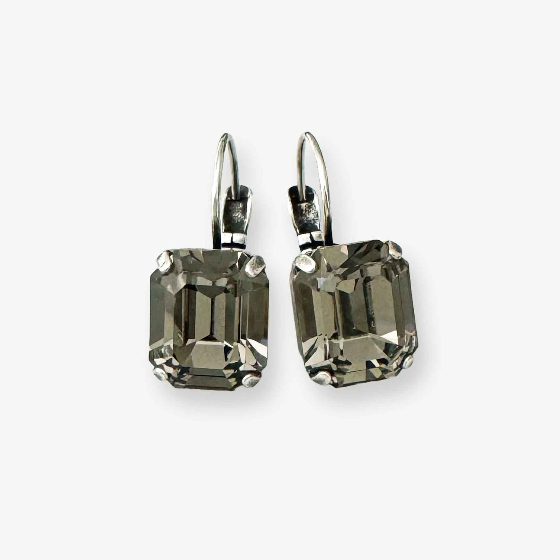 Gray crystal earrings in a rectangular emerald cut. Shown in antique silver.