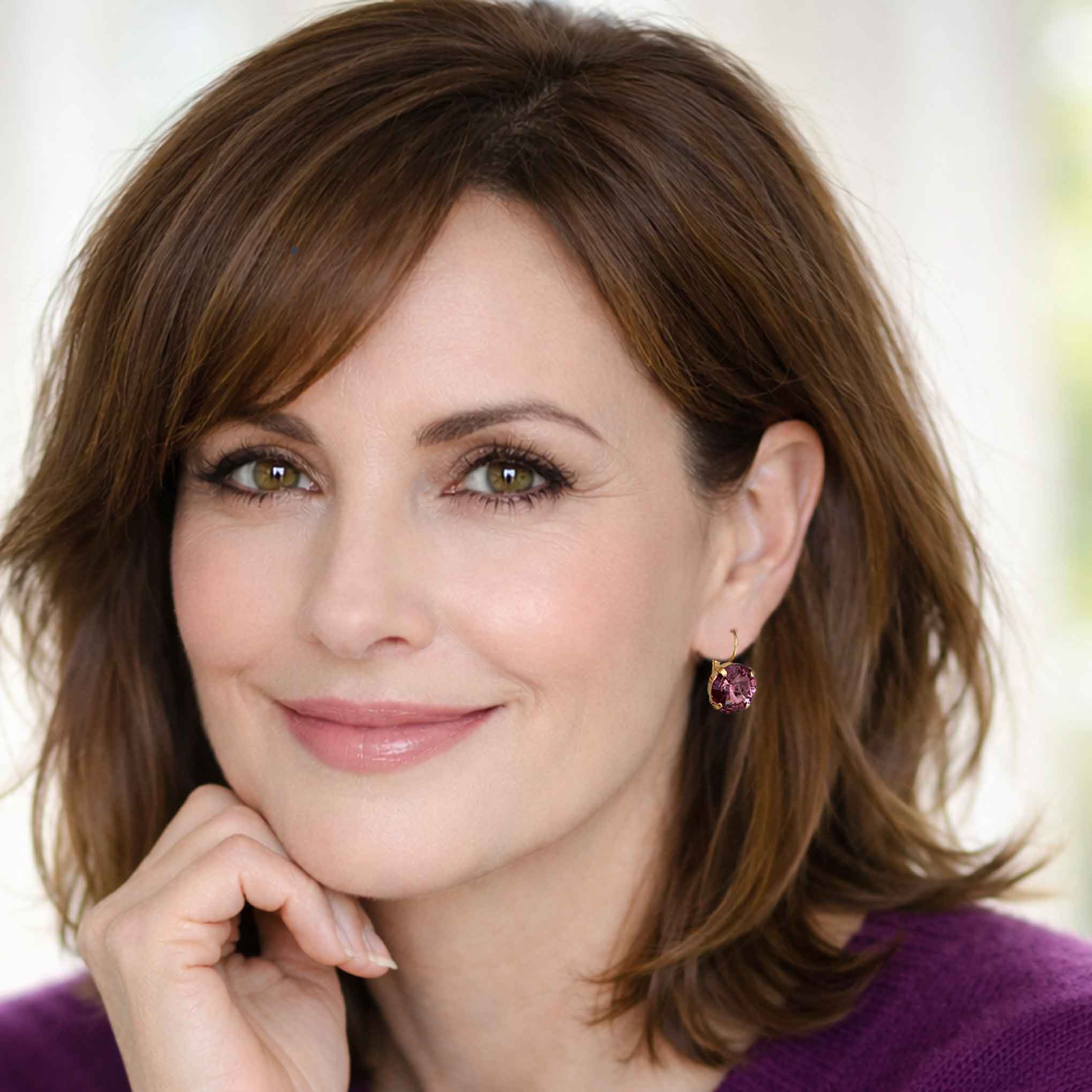 Woman modeling purple drop earrings by Petite Margaux.