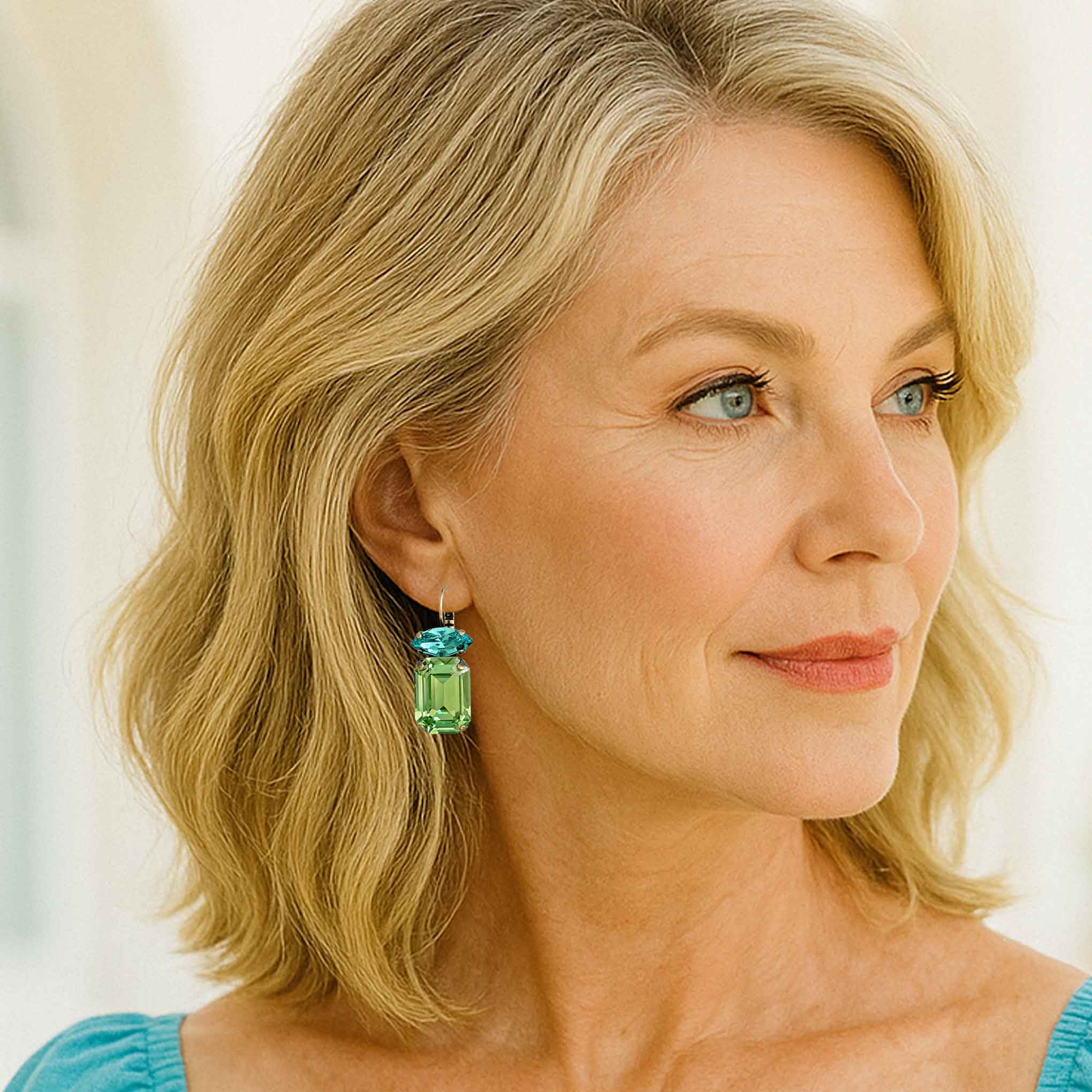 Middle aged model wearing the earrings.