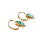 Side view of gold and turquoise earrings.