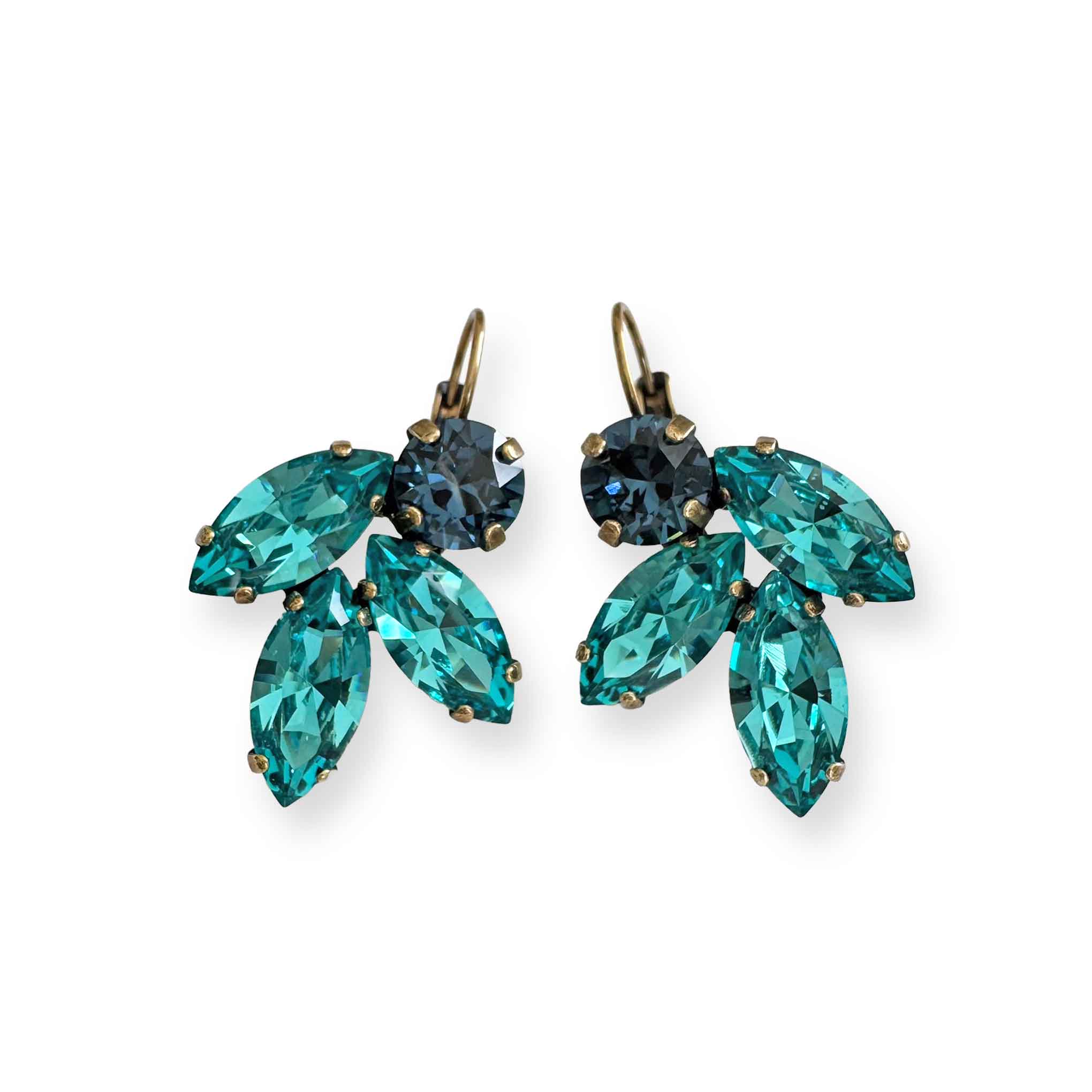 A pair of handmade crystal earrings featuring marquise-cut Caribbean blue and round navy blue crystals, arranged in a leaf-inspired cluster and set in antique brass leverback settings. Earrings are displayed against a white background.