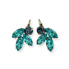 A pair of handmade crystal earrings featuring marquise-cut Caribbean blue and round navy blue crystals, arranged in a leaf-inspired cluster and set in antique brass leverback settings. Earrings are displayed against a white background.