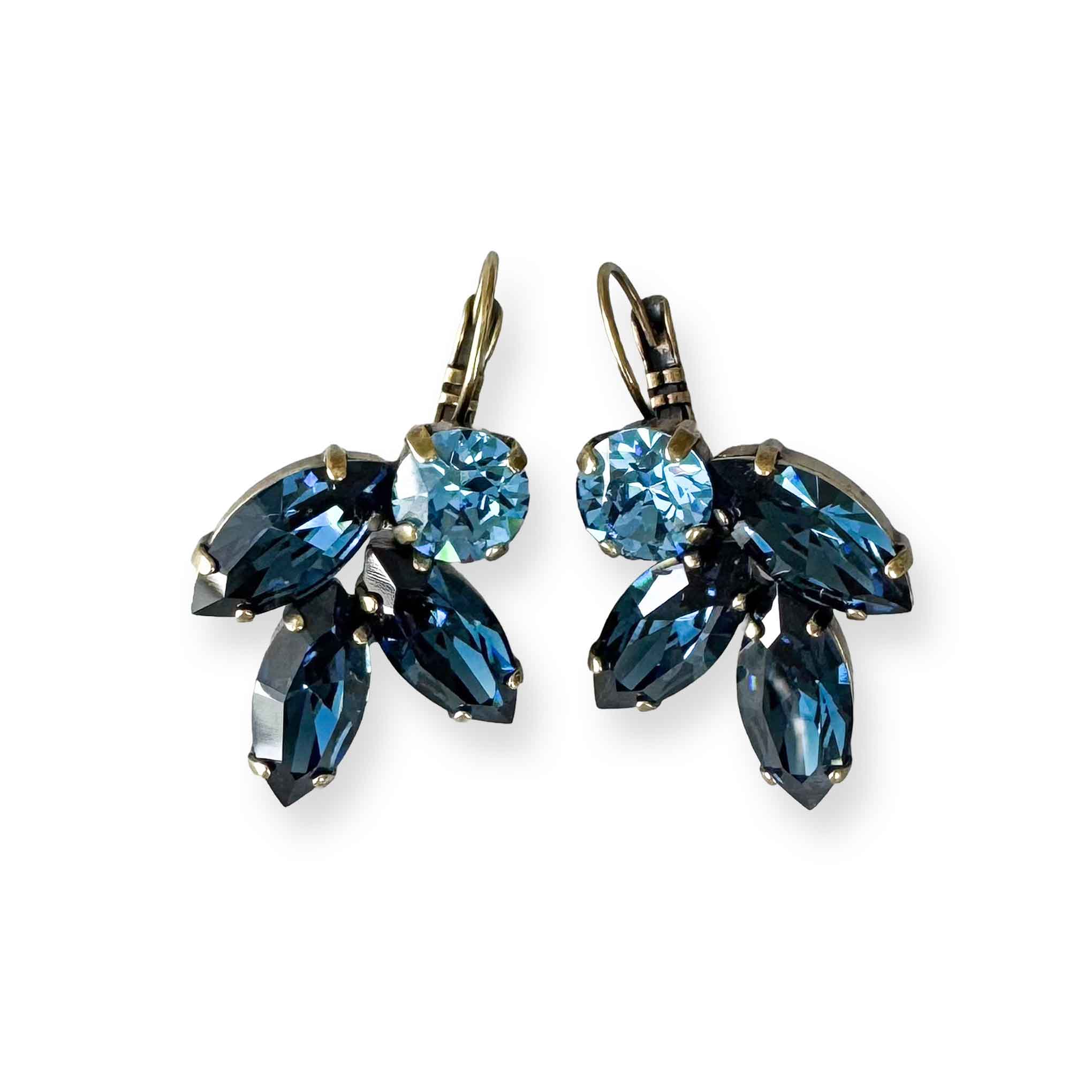 Dark, montana blue and cool blue crystal earrings with a leaf motif.