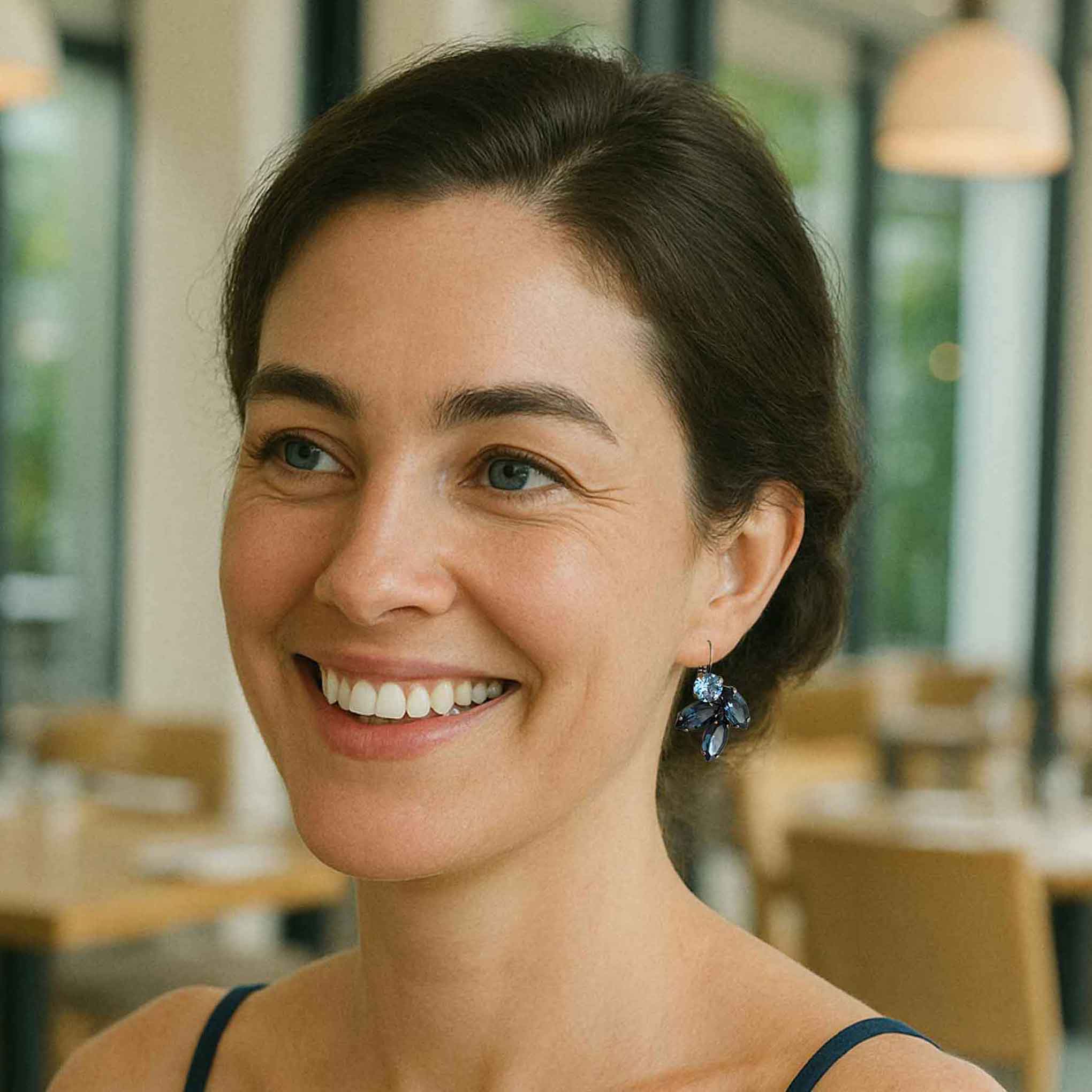 Model wearing Petite Margaux blue crystal rhinestone earrings.