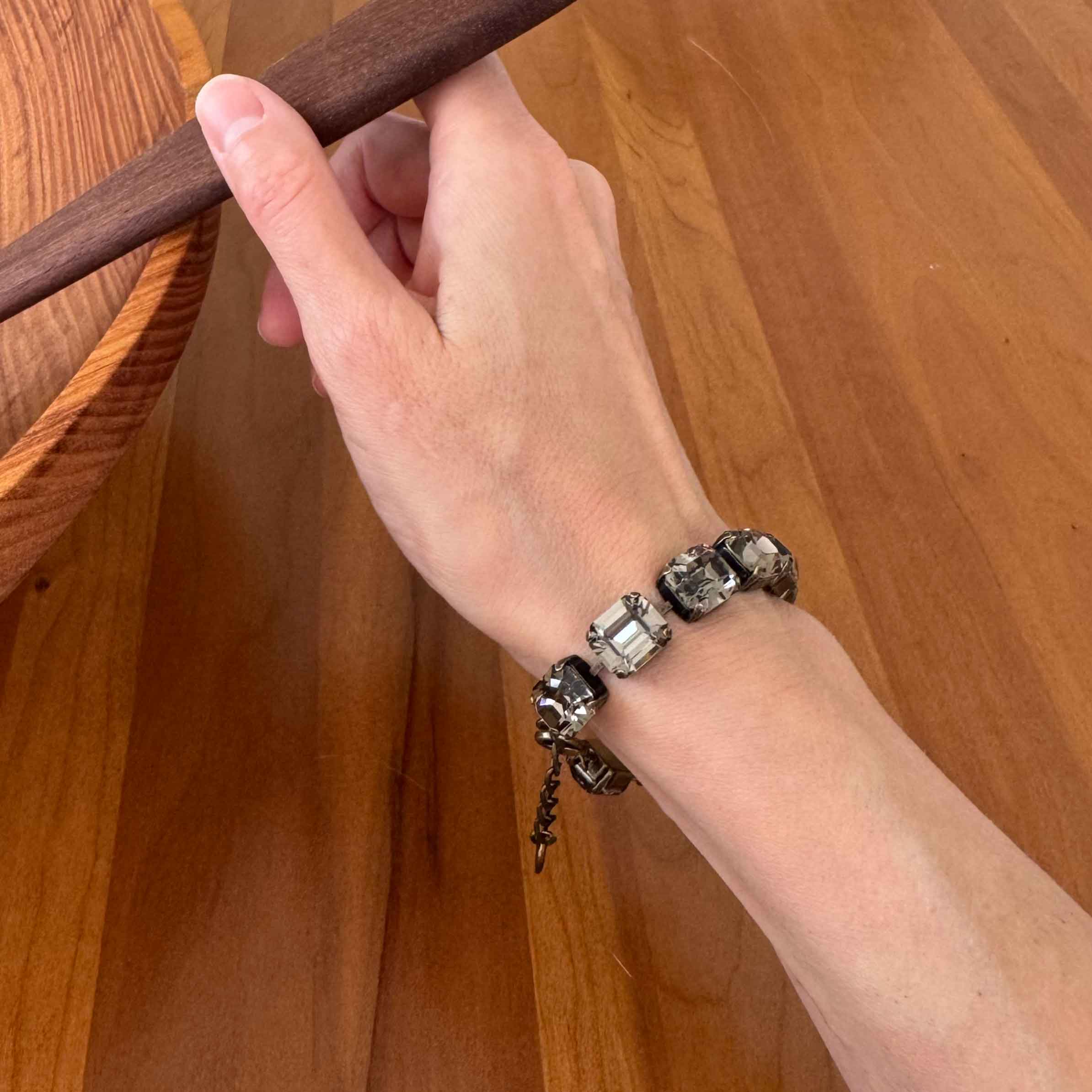 Emerald cut black diamond crystal bracelet by Petite Margaux shown on a wrist.