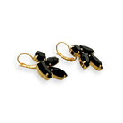 Side view of black marquise cut earrings in gold.