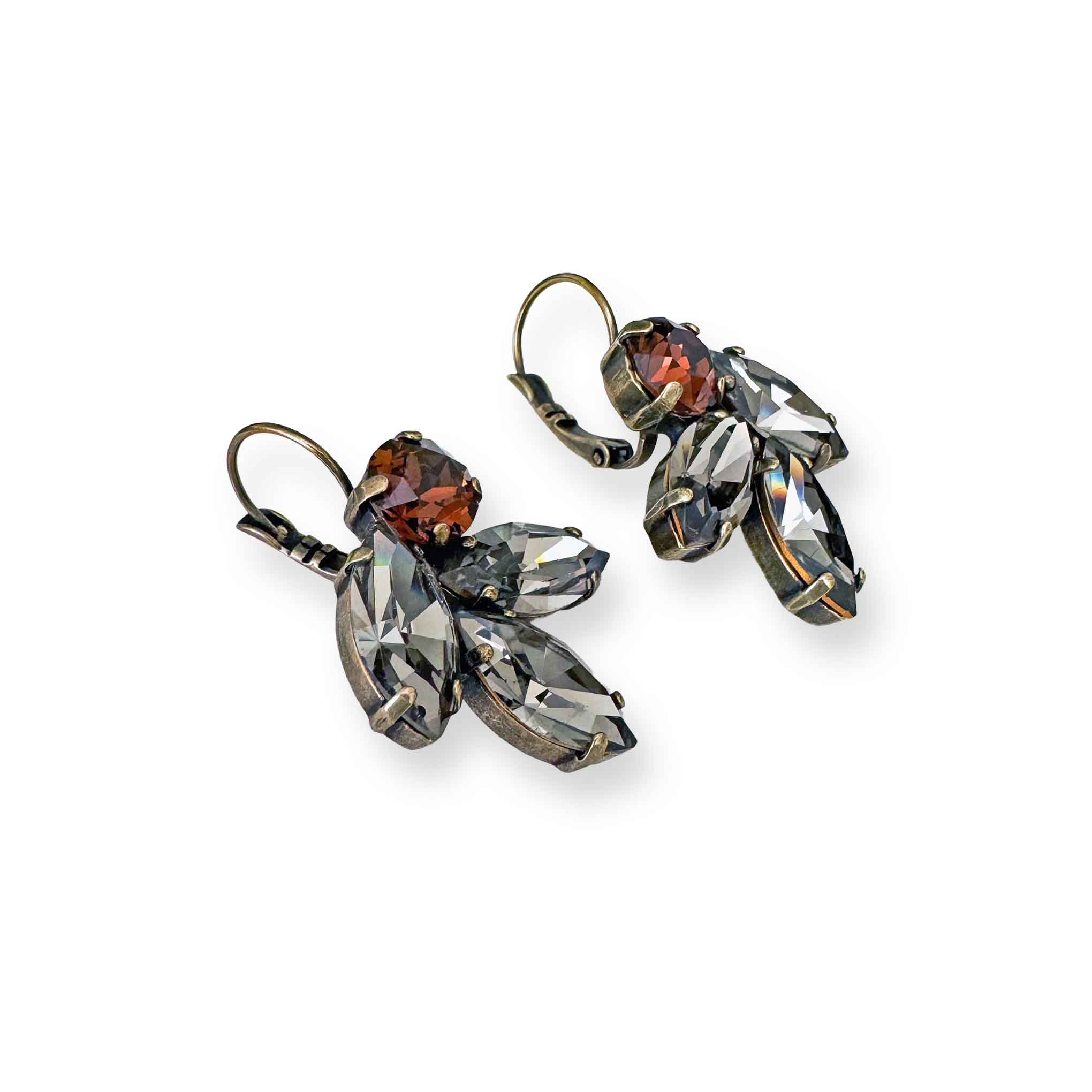 Side view of black and brown costume earrings shown in antique brass.