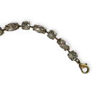 close up of antique brass version of warm gray crystal bracelet.