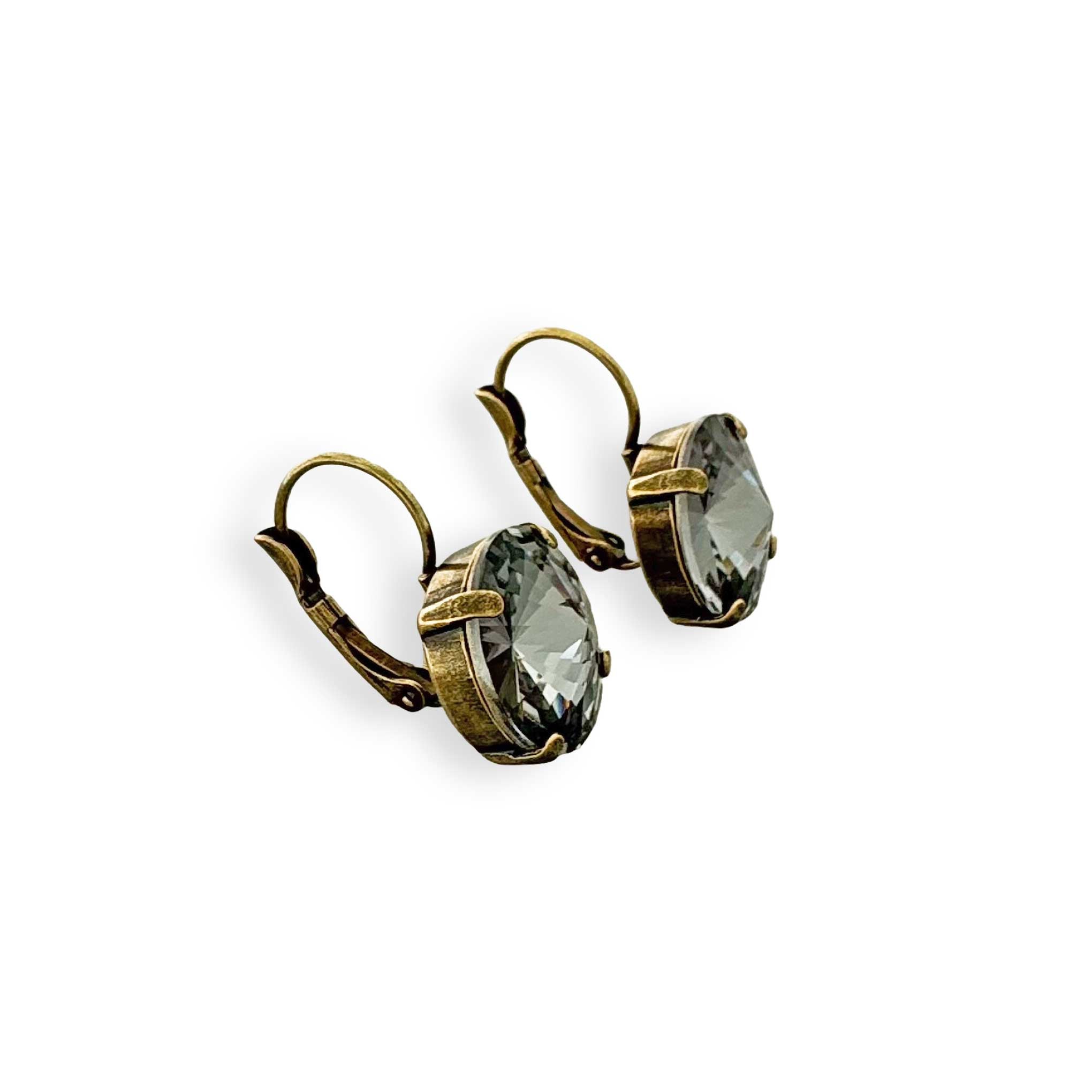 Antique brass and black rivoli earrings shown in side view.