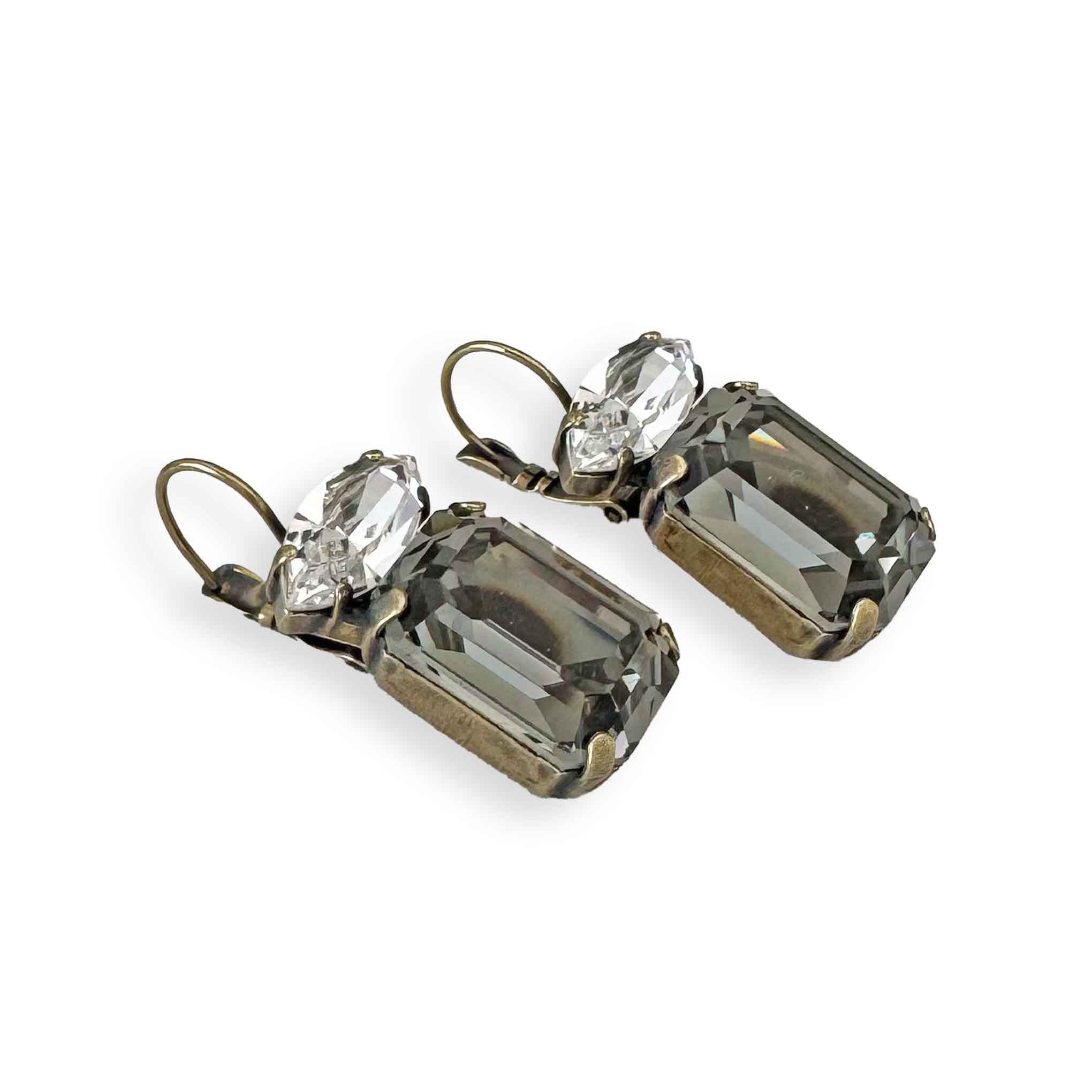 Side view of clear and black diamond crstal drop earrings showing lever-back and antique brass finish.