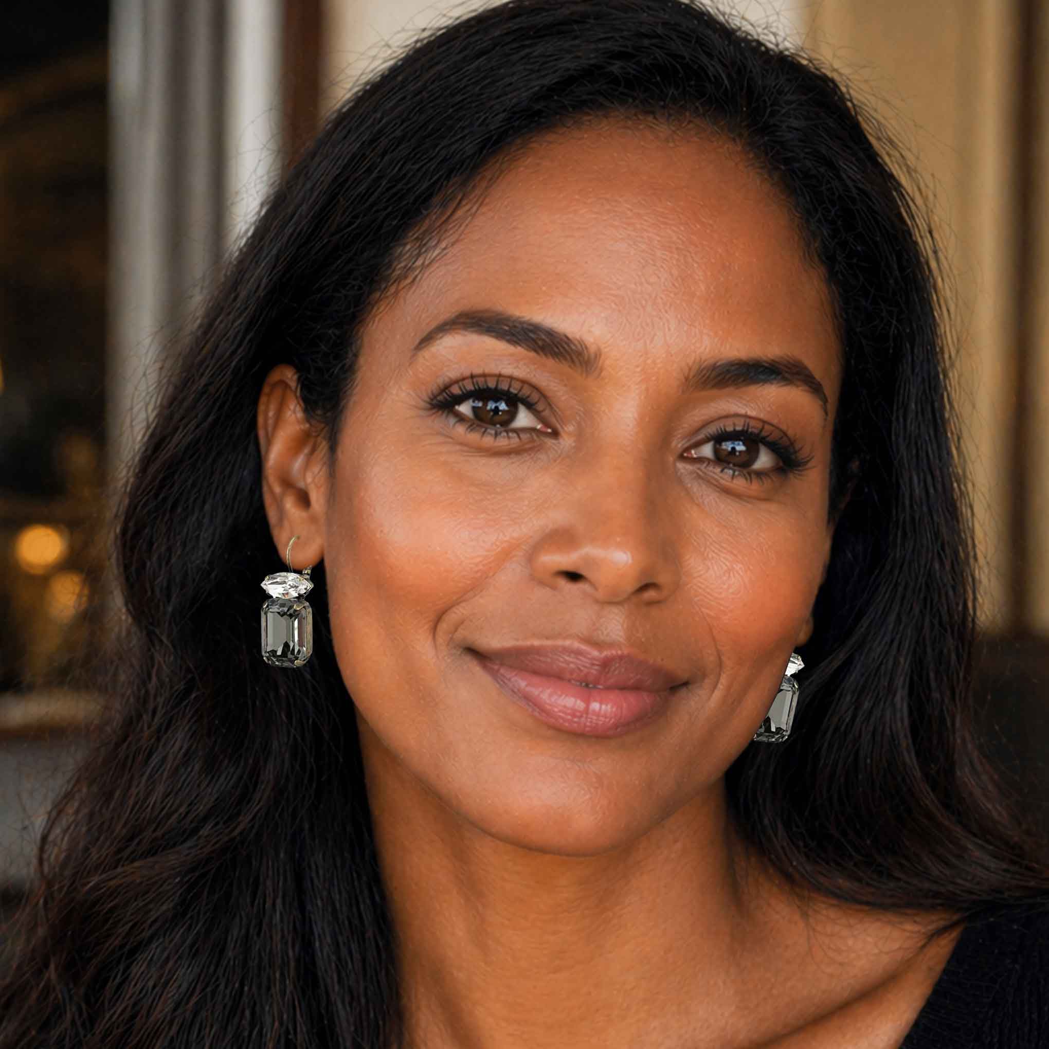 Attractive black women wearing clear and black emerald cut crystal earrings by Petite Margaux.