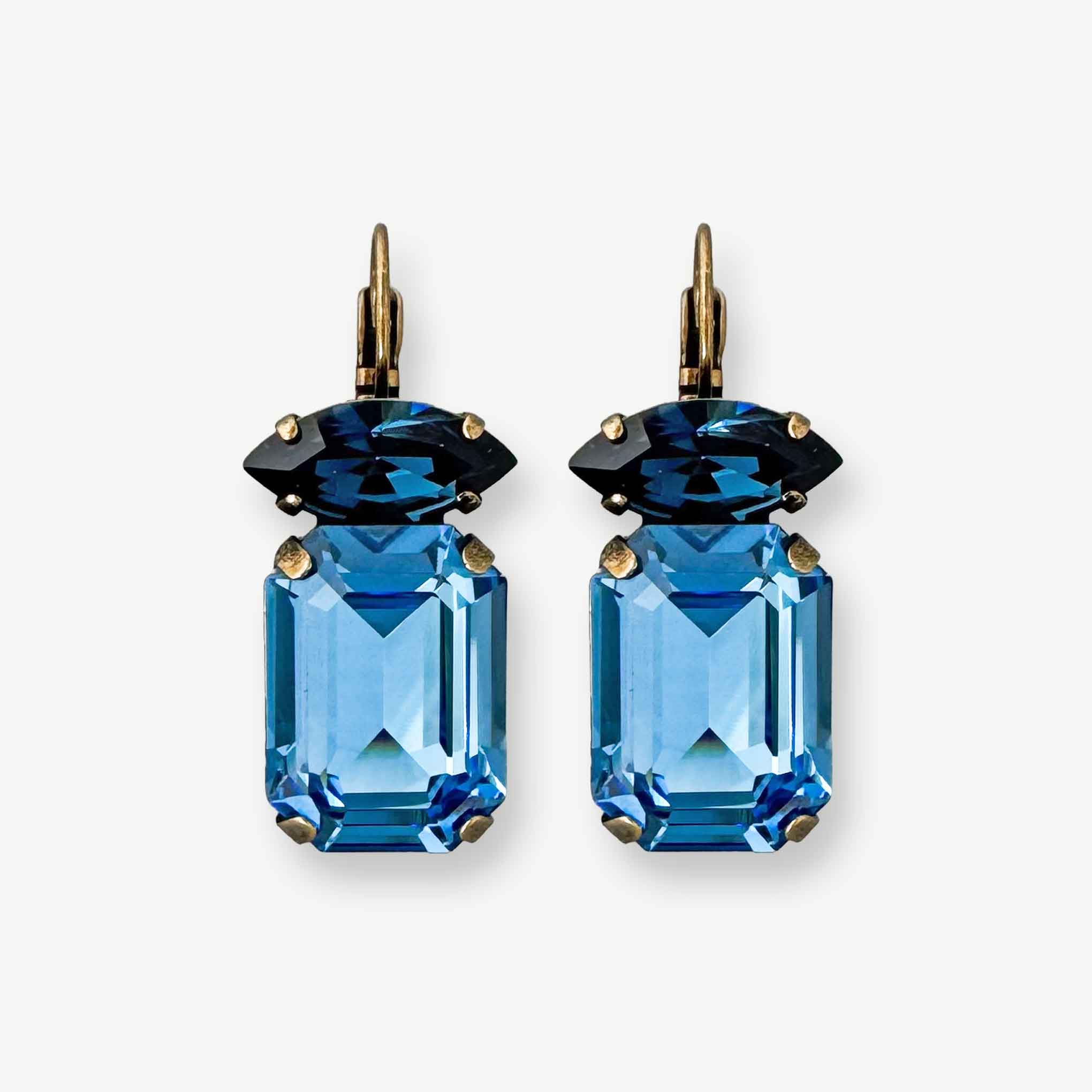Emerald and marquise cut blue crystal drop earrings shown in antique brass.