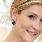 Bride with blue eyes wearing crystal blue earrings for her something blue.