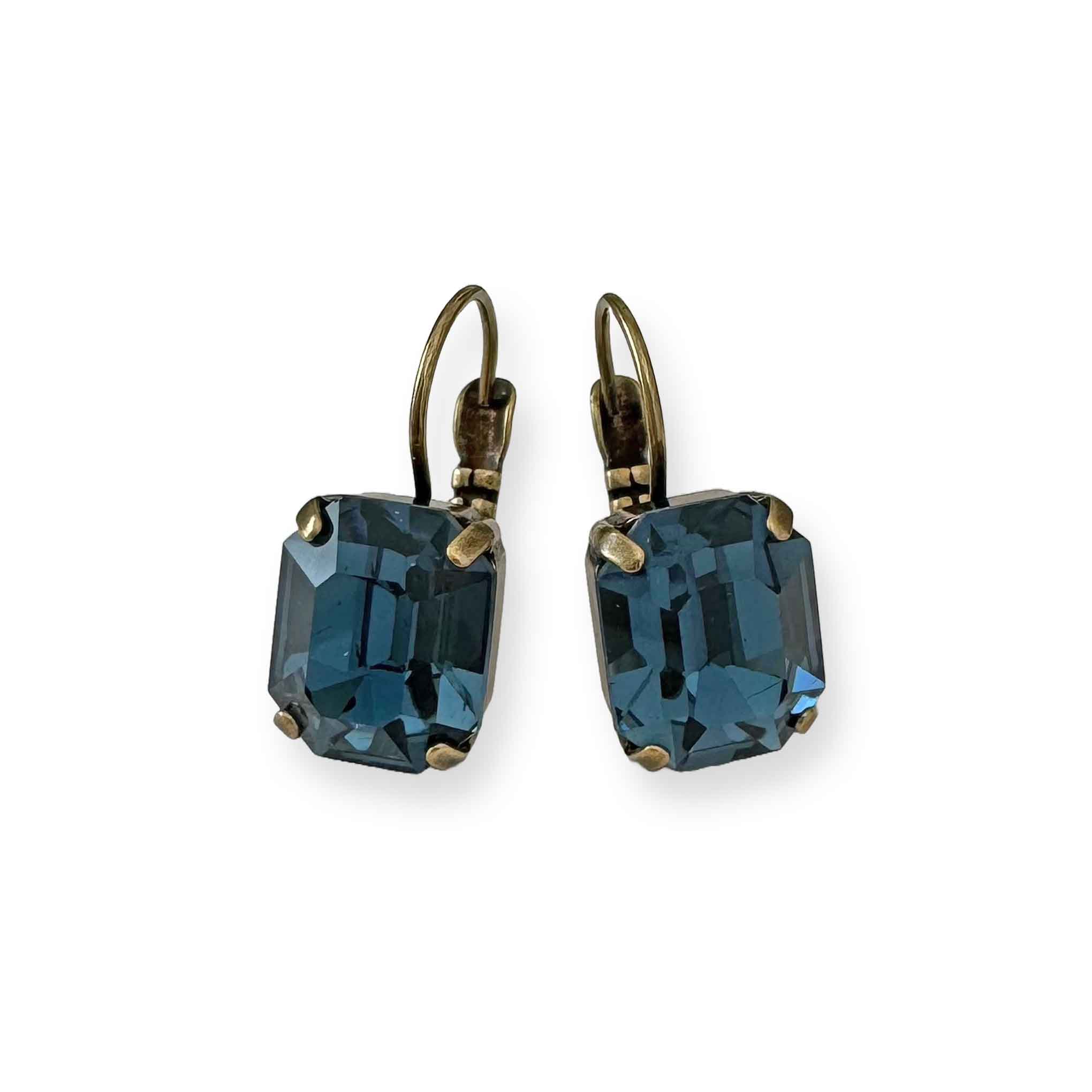 Emerald-cut blue crystal earrings shown in antique brass.