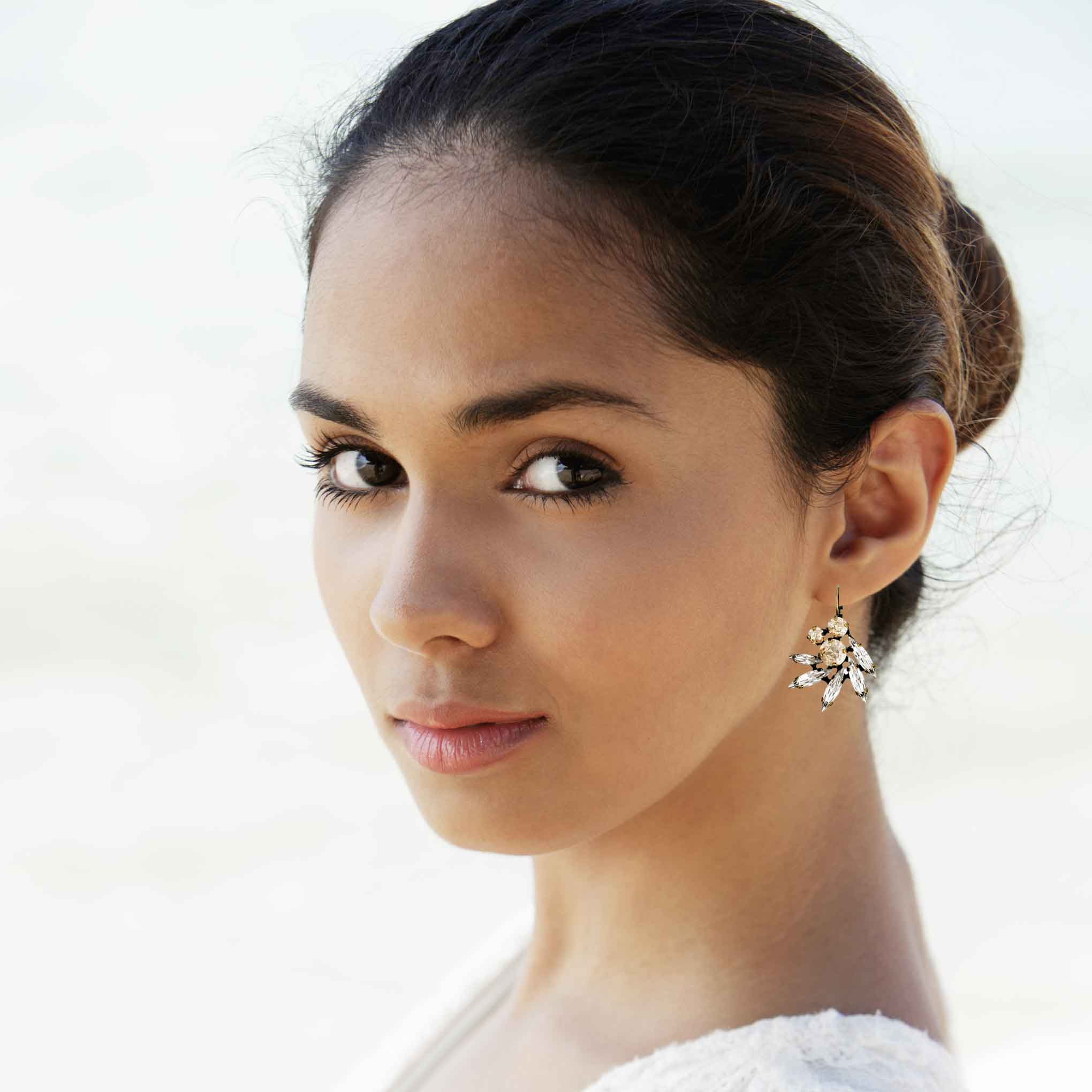 Bride wearing crystal drop wedding earrings by Petite Margaux.