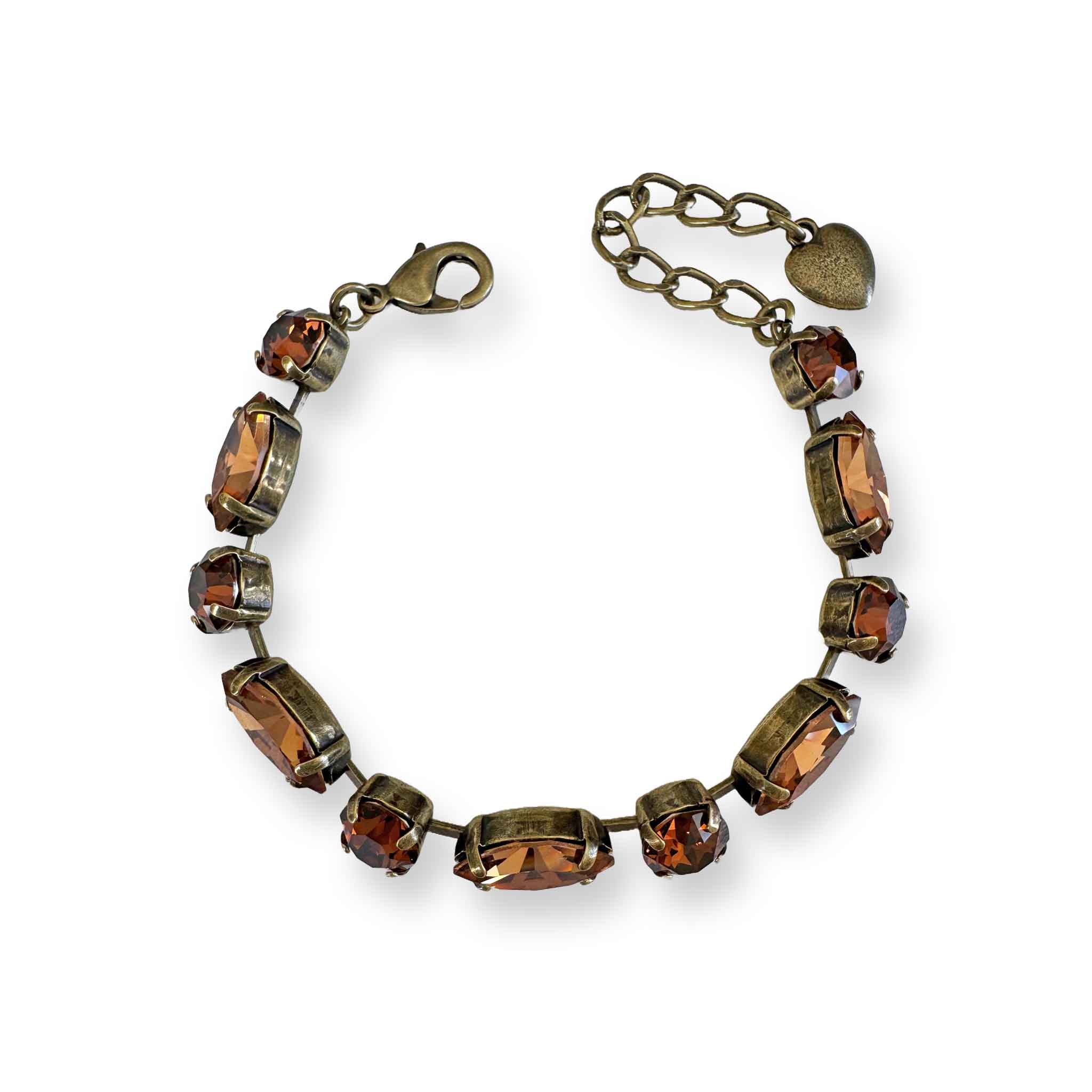 Vintage style brown crystal bracelet with smokey topaz colored crystals. Shown in antique brass with an adjustable extender.