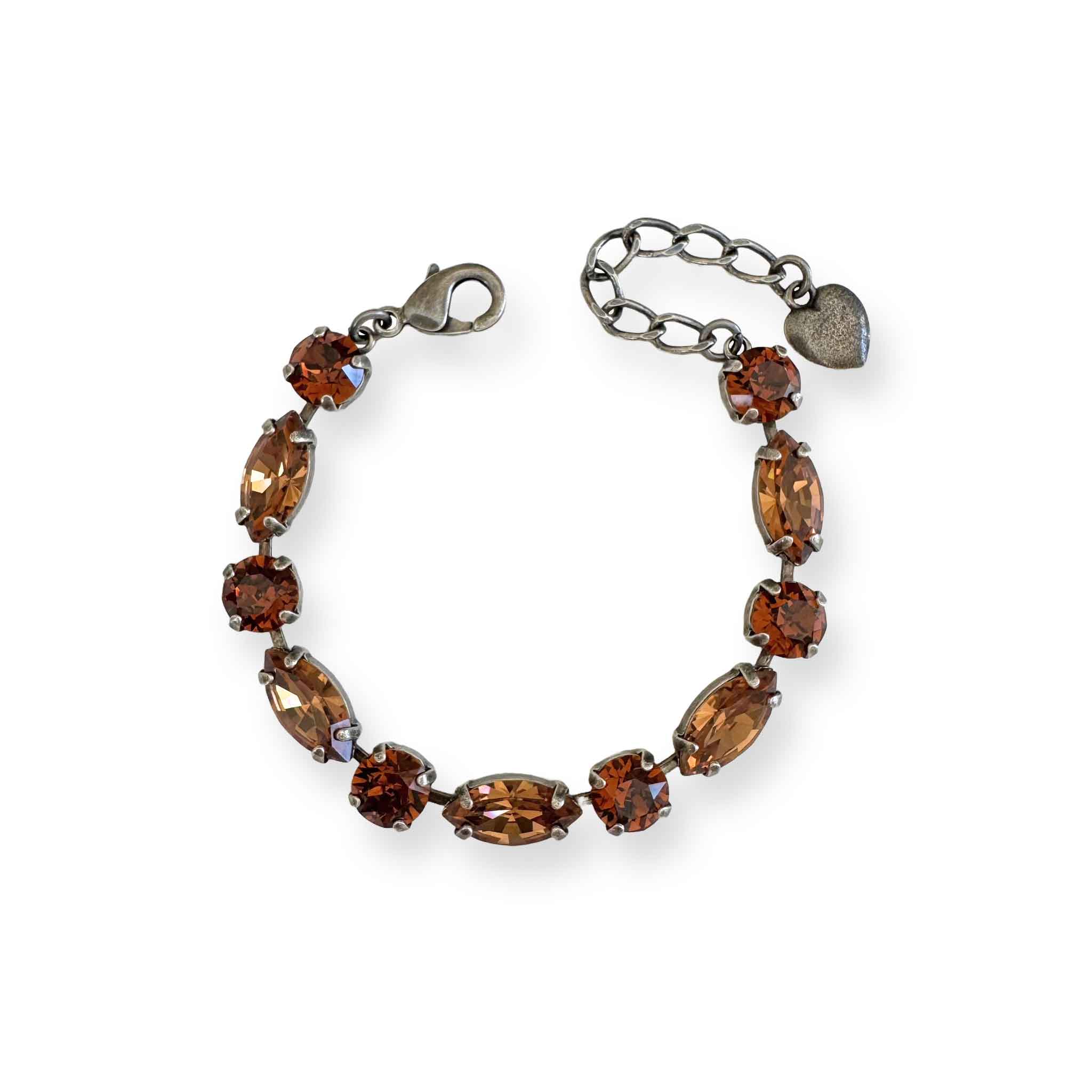 Bracelet with brown crystals in silver settings on a white background.