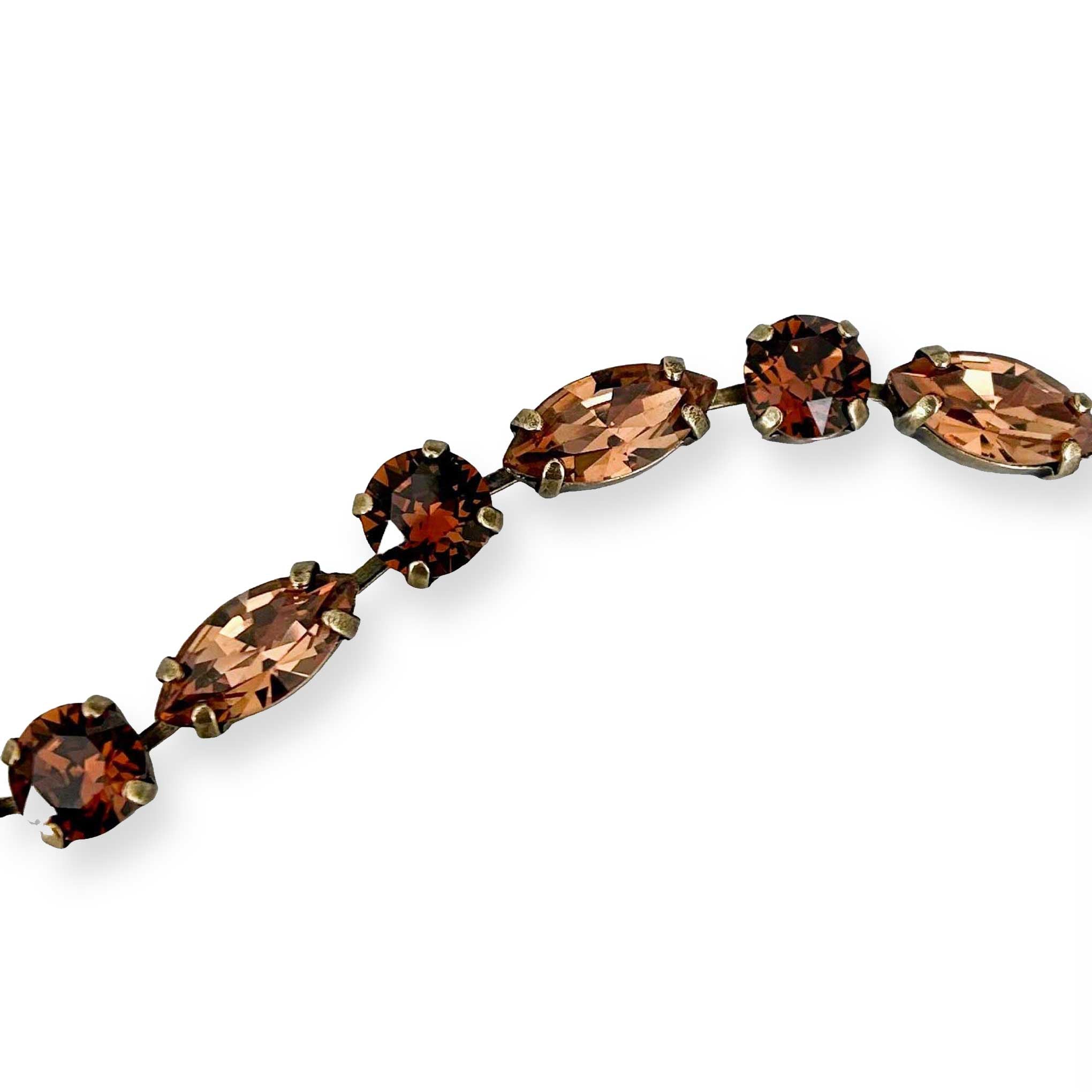 close-up of round and marquise cut crystal stone bracelet in dark and light browns.