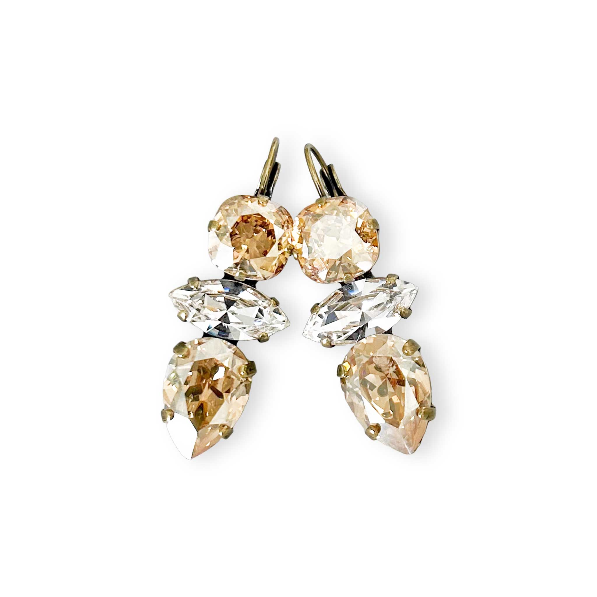 Clear and champagne color crystal rhinestone statement earrings shown in antique brass.