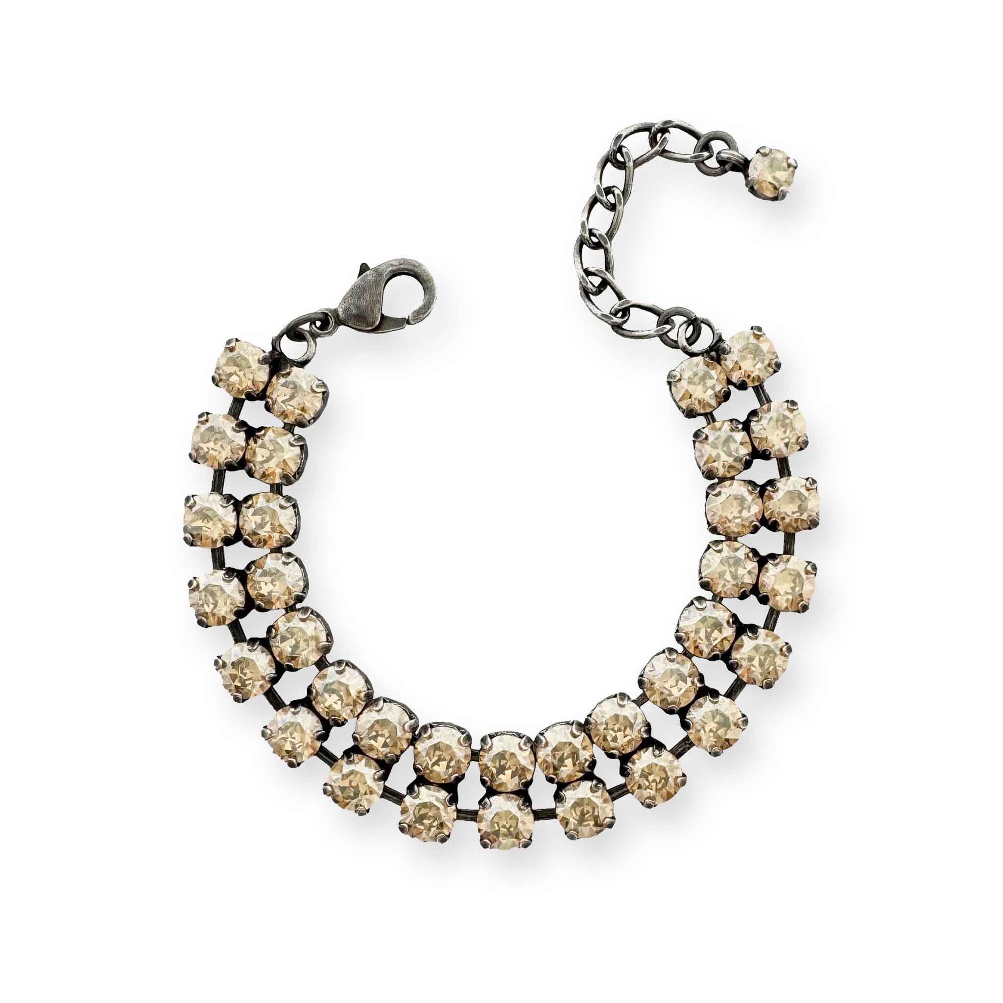 Double row crystal bracelet with gold champagne colored cut crystals. Shown in antique silver and adjustable.