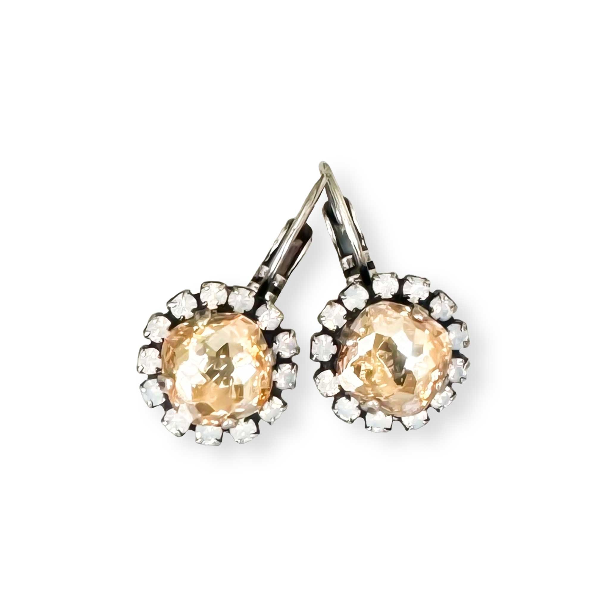 Crystal daisy earrings with white opal and golden shadow Austrian crystals. Shown in antique silver.