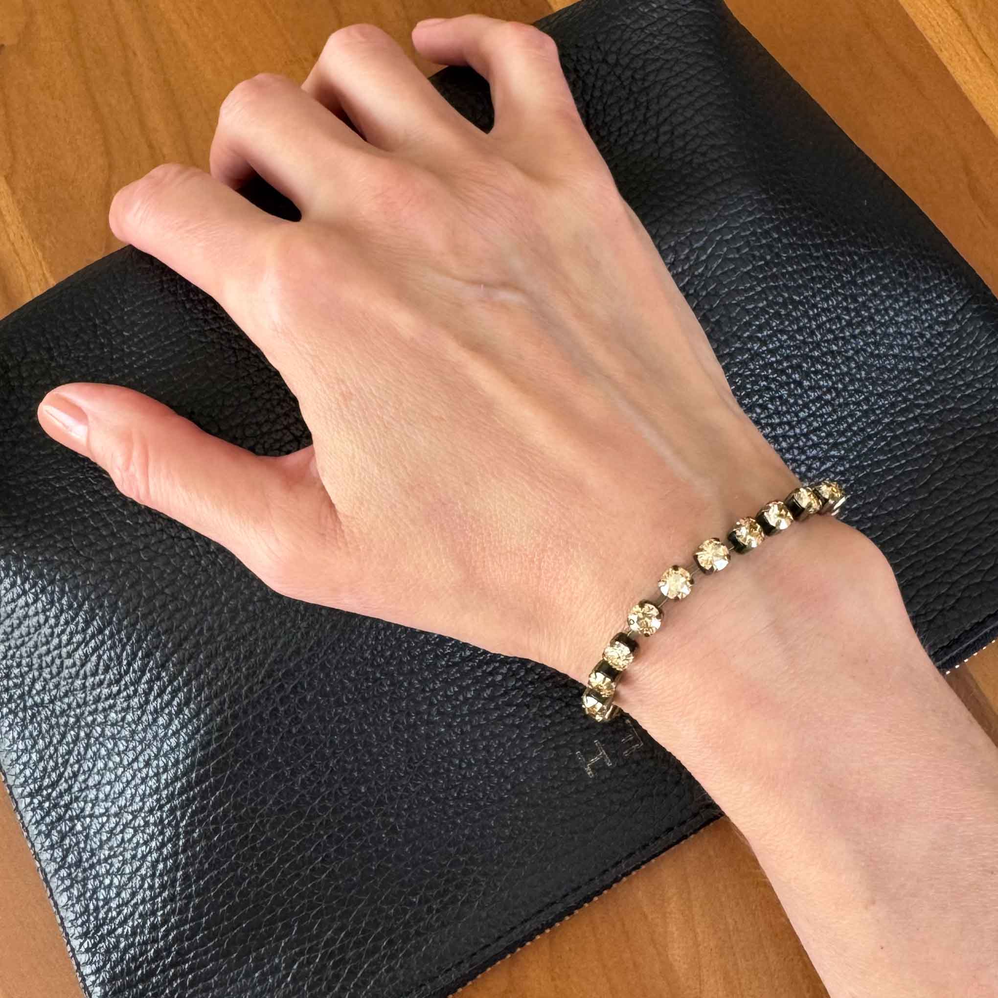 Golden champagne crystal bracelet shown on a wrist.
