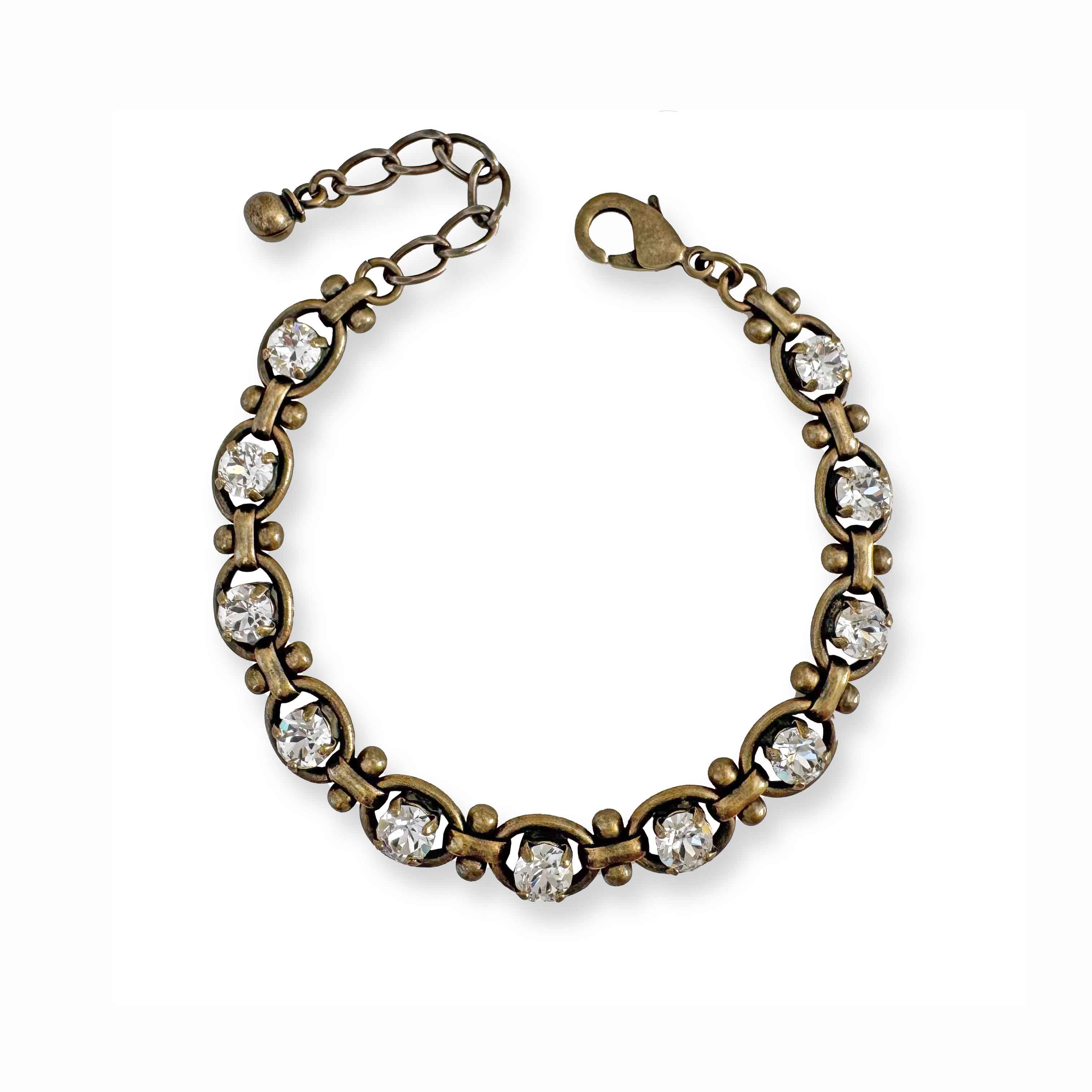 Clear crystal and antique brass link bracelet on white background.