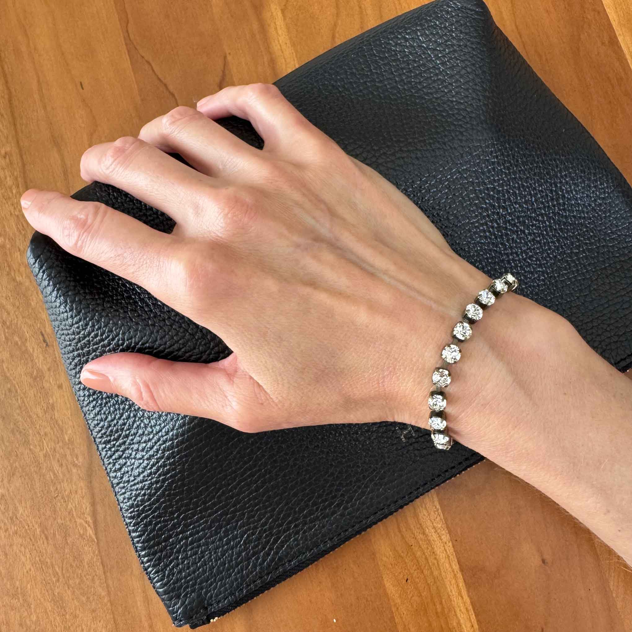 Vintage style clear crystal bracelet shown on a wrist.