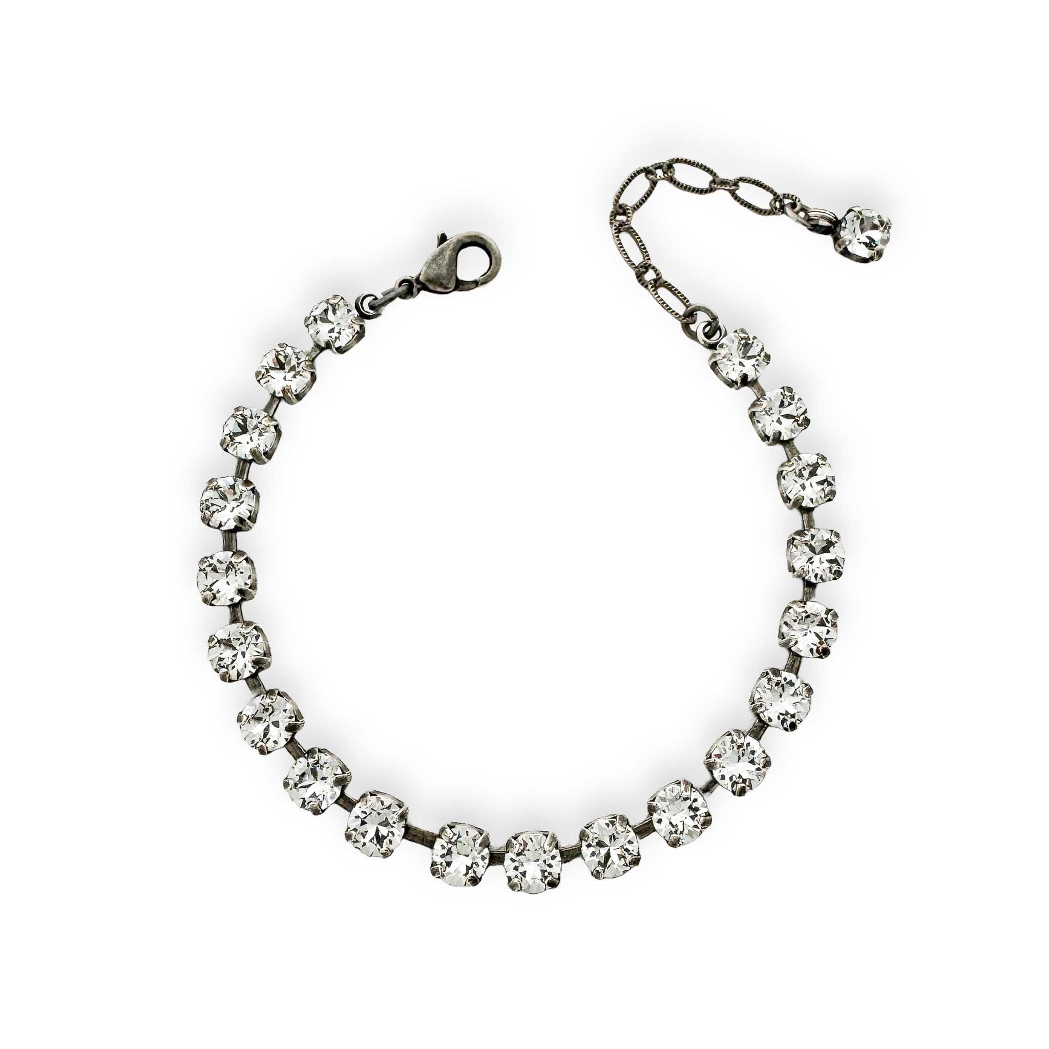 Delicate clear crystal tennis bracelet made of Austrian crystal shown in antique silver.