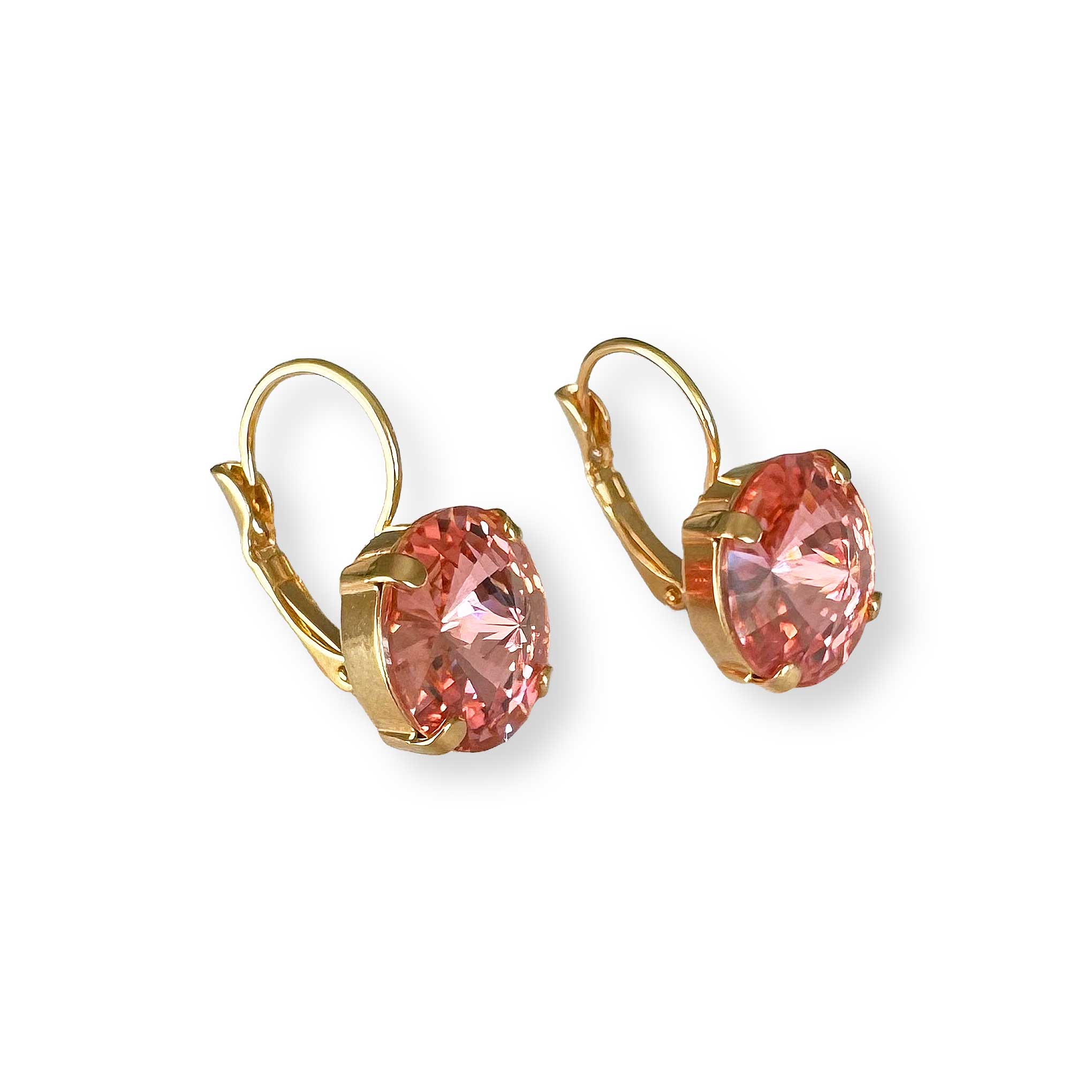 Gold drop earrings with peach coral crystals on a white background. Angled view.