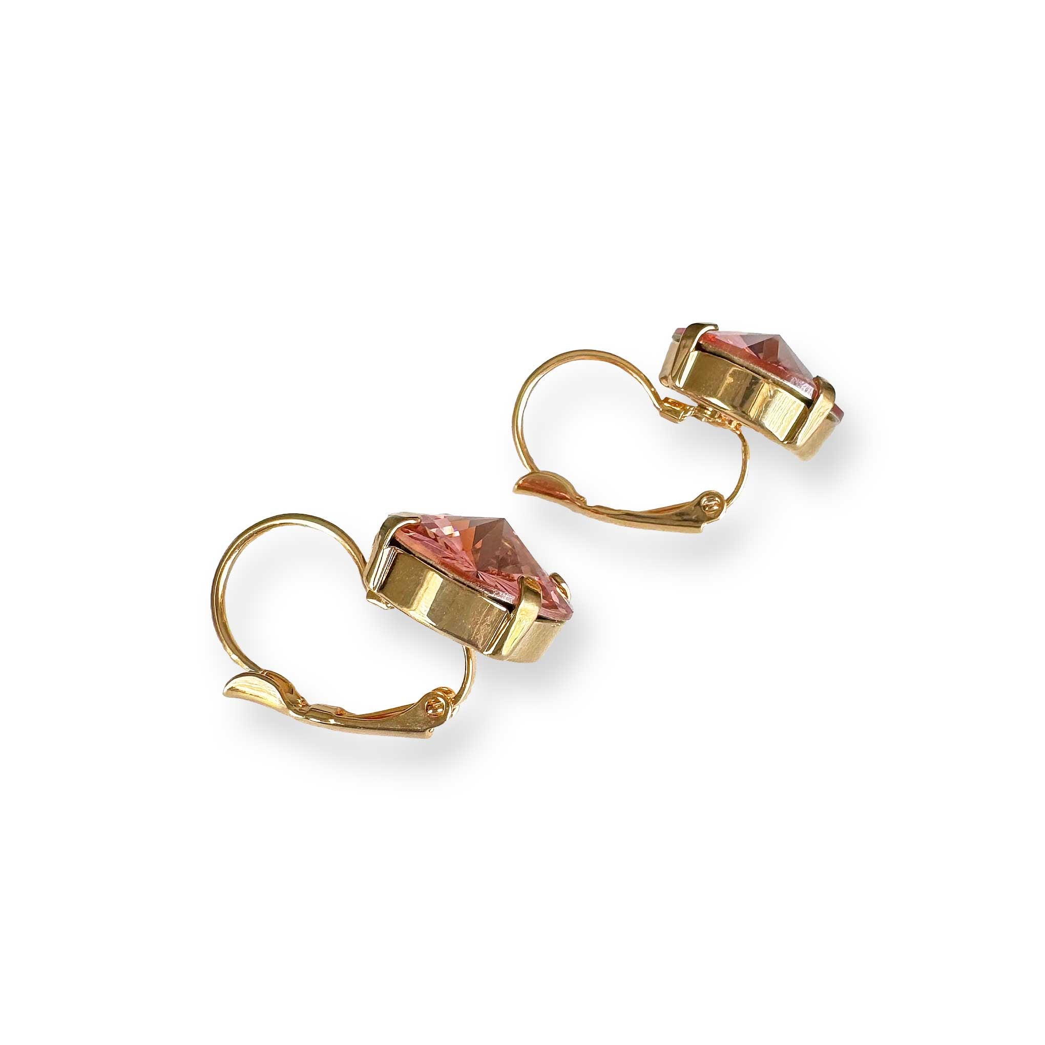 Flatlay view of coral crystal drop earrings to show shape of crystal.