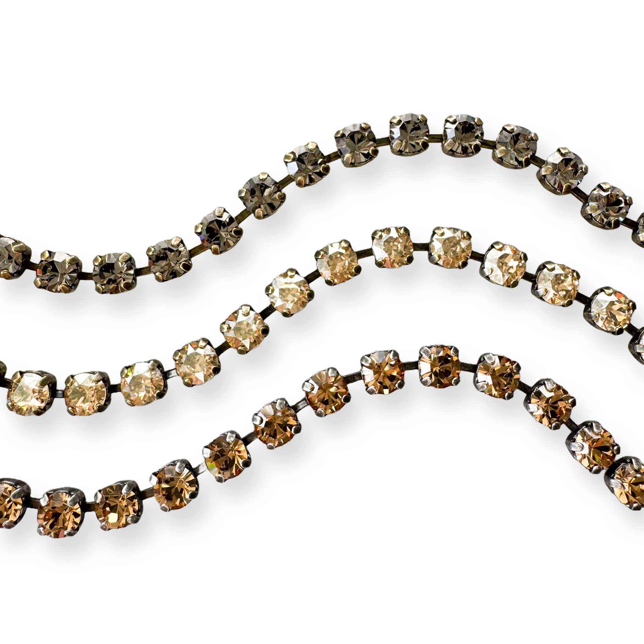 Close up of three neutral rhinestone bracelets by Petite Margaux.