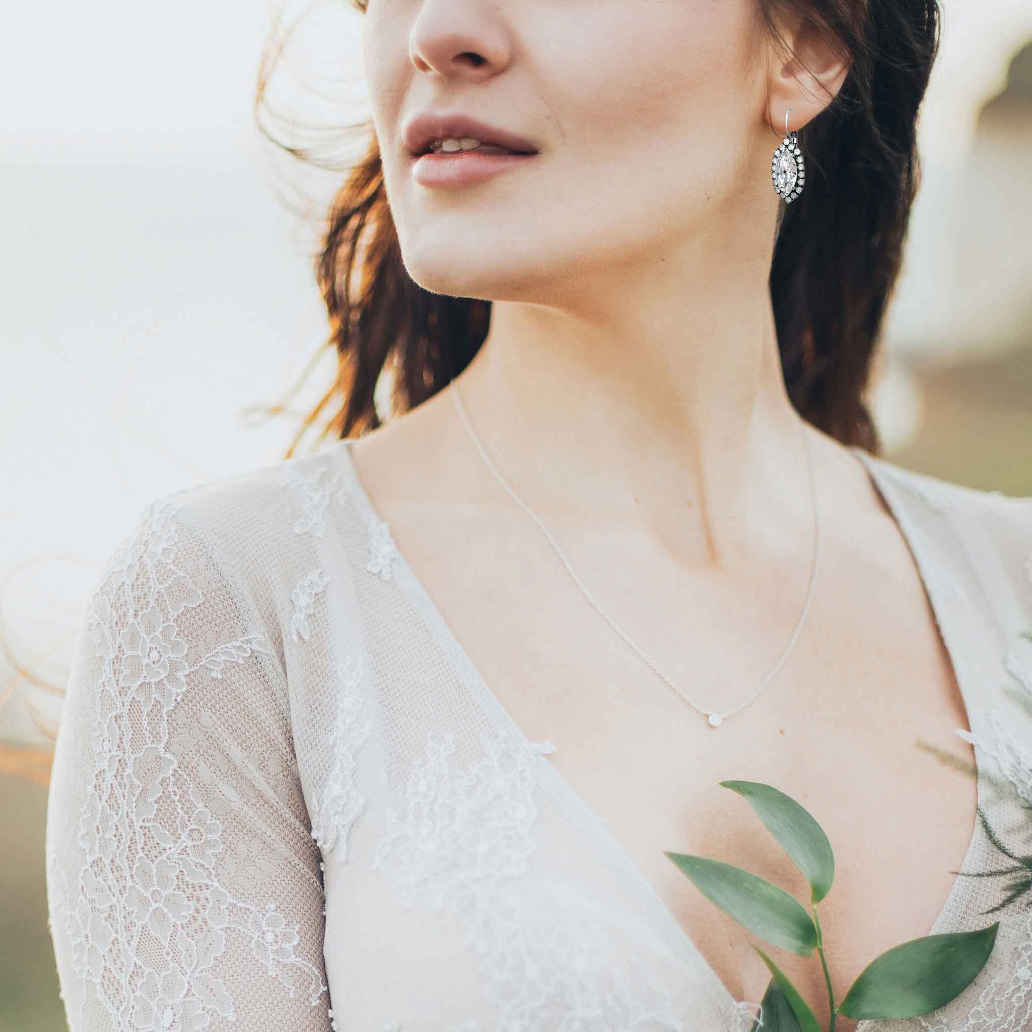 Romantic vintage bride wearing marquise cut crystal drop earrings.